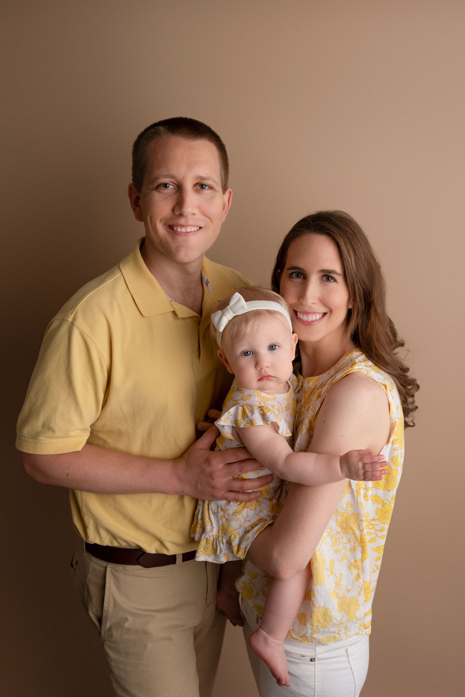 Family portrait series in matching yellow and beige outfits against a neutral brown backdrop.