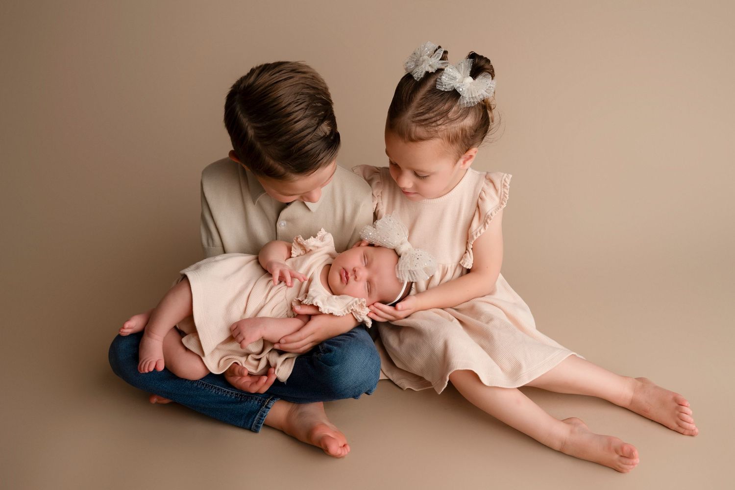 A collection of candid family moments captured in soft pink and blue tones showing tender interactions and embraces.
