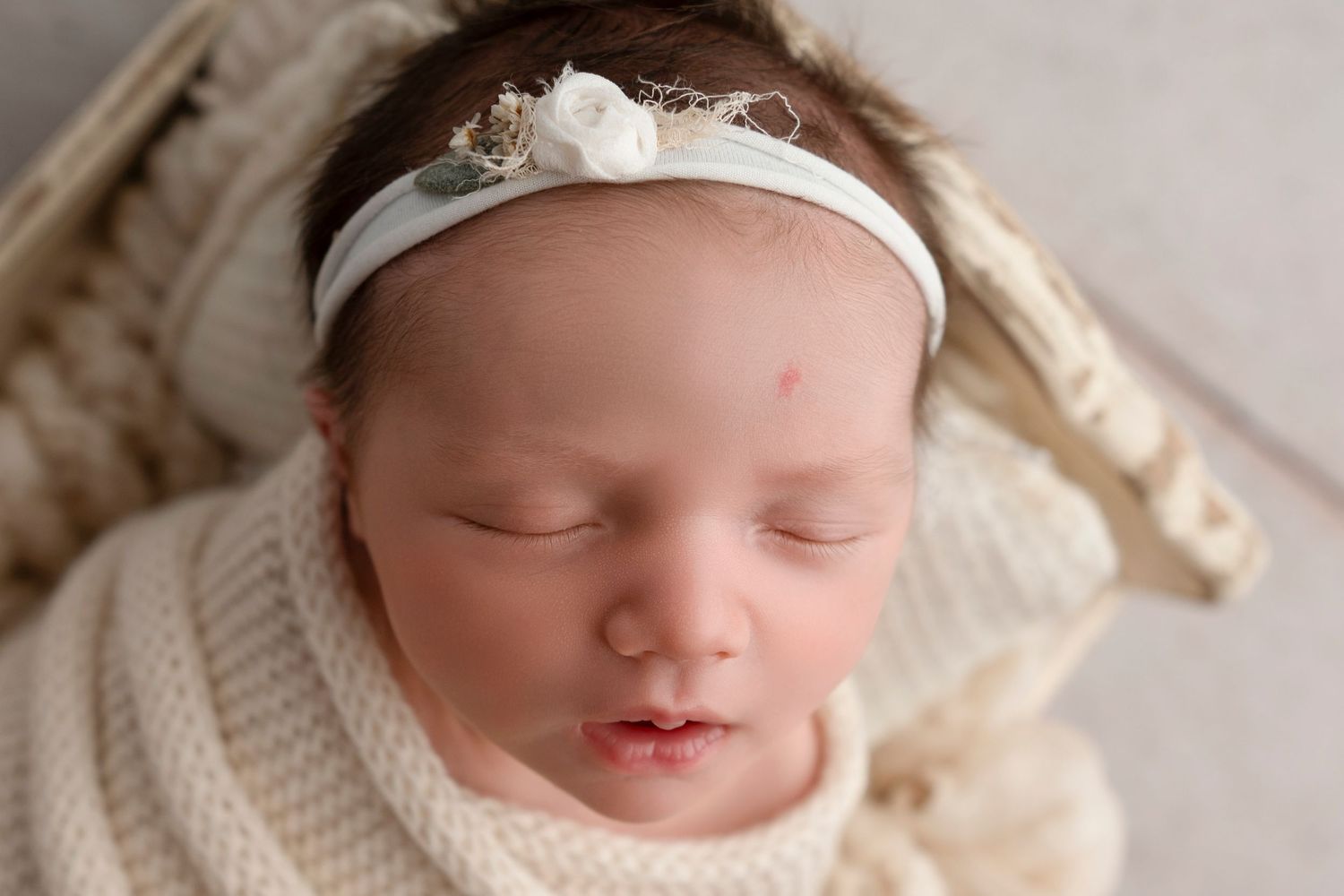 Collection of peaceful sleeping newborn portraits with white lace and cream accents.