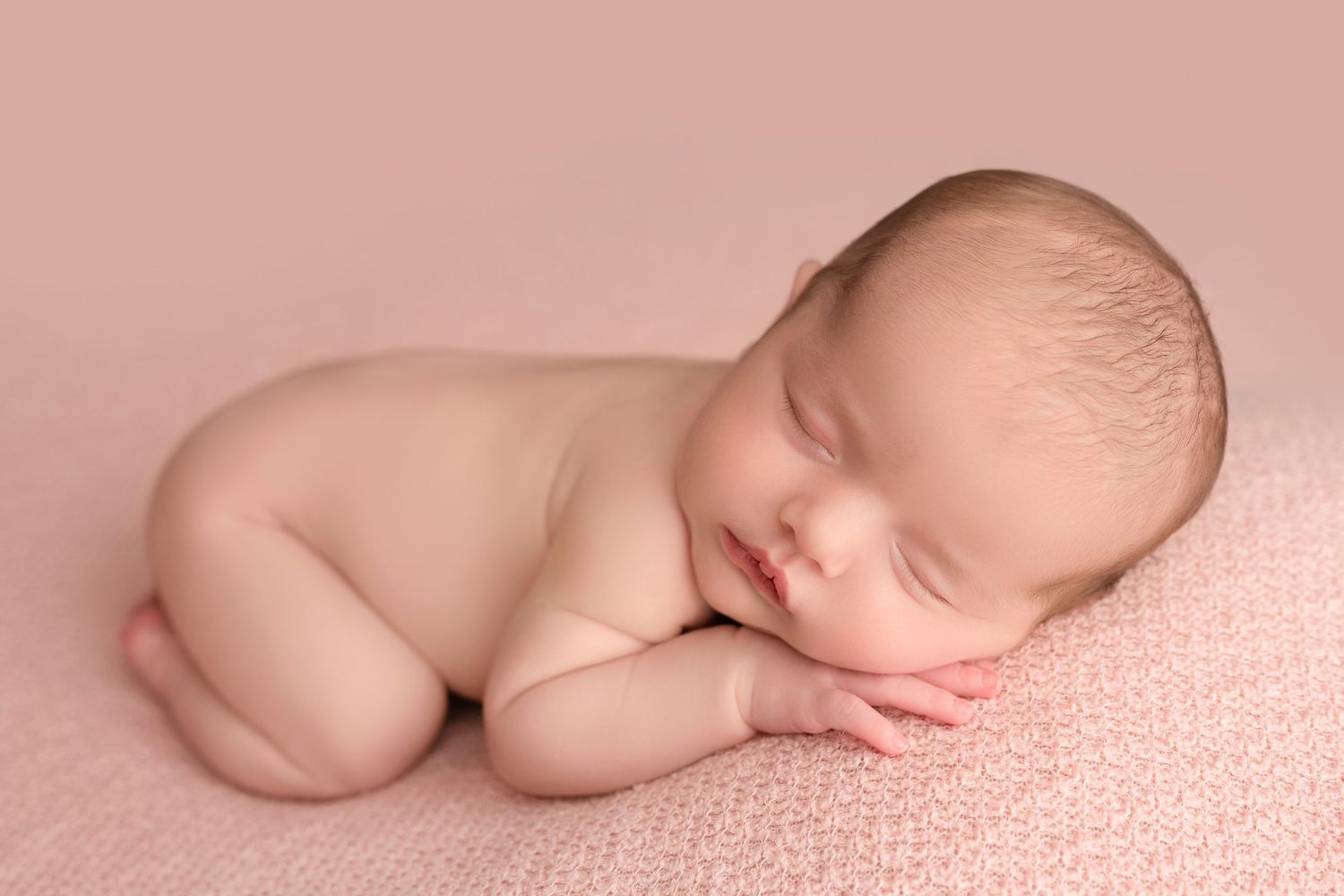 A series of minimalist newborn photography poses on a soft pink backdrop showing gentle curves and delicate details.