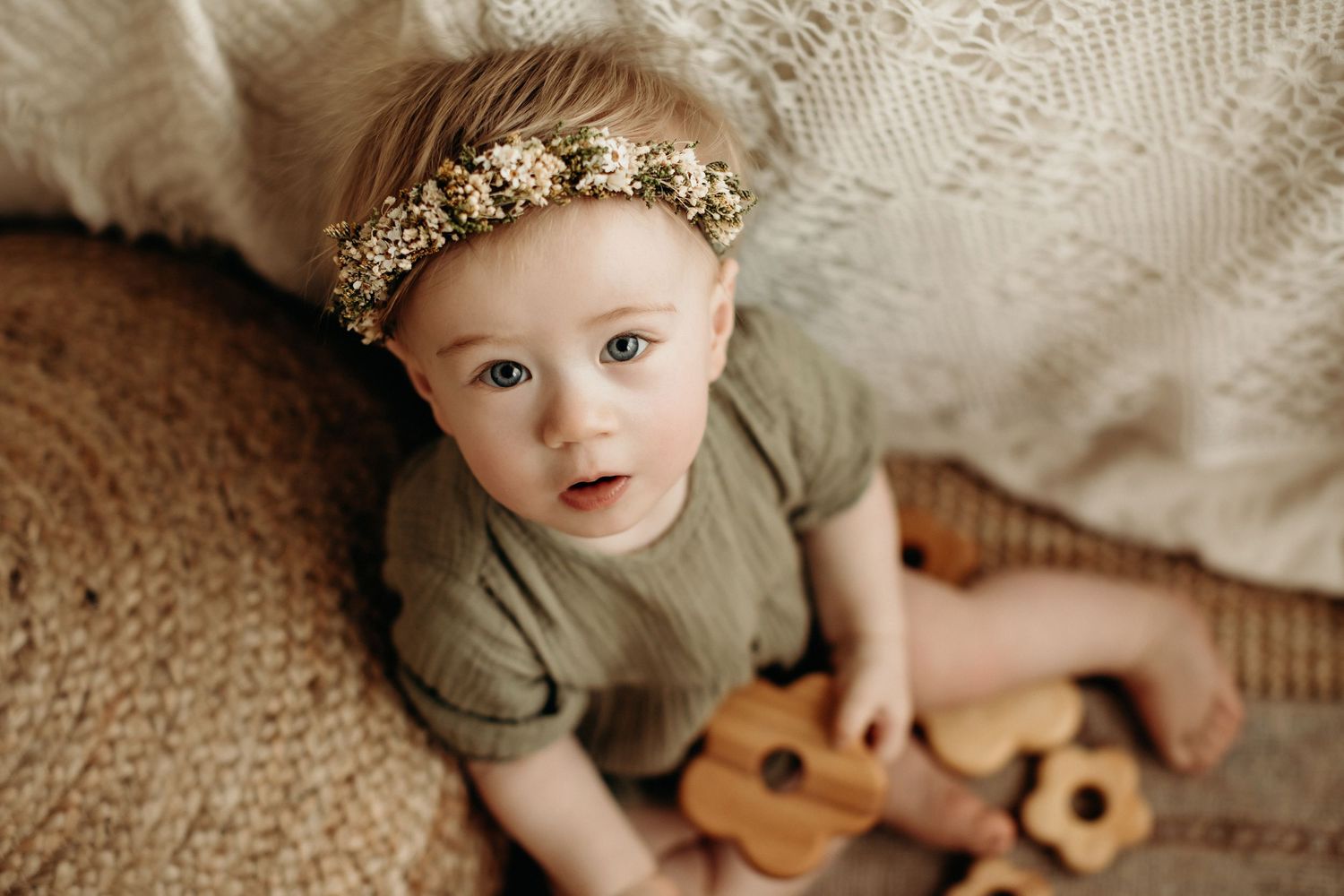 A set of lifestyle photos showing an infant playing with a wooden toy ukulele in various candid moments.