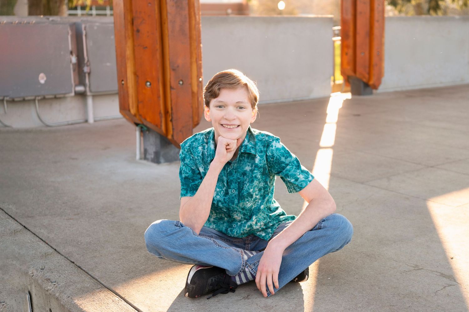 A series of casual outdoor portrait photos showing someone in a teal patterned shirt and jeans in various relaxed poses.