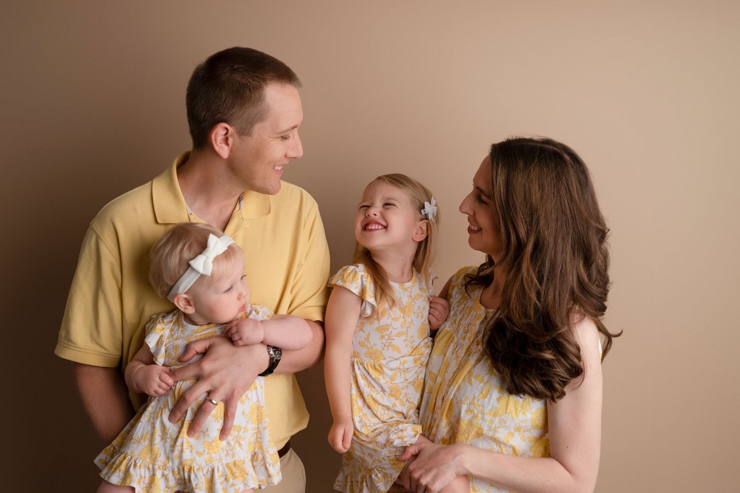 A series of candid family photos showing parents and young children sharing joyful moments together.