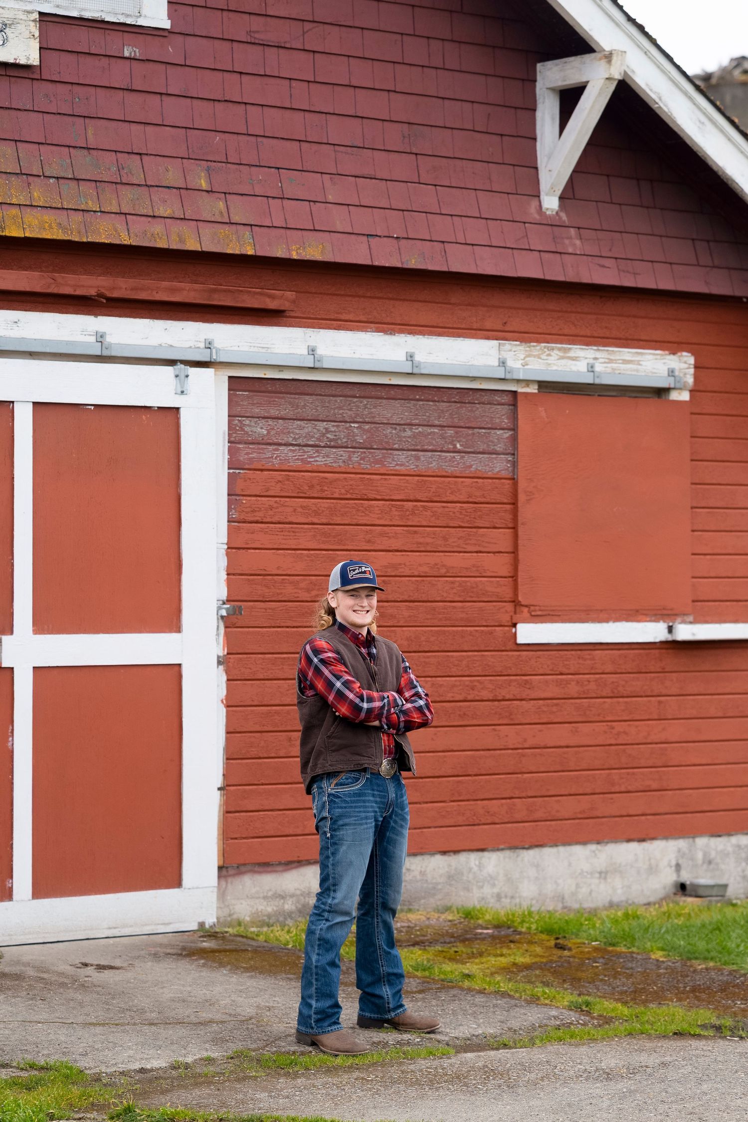 A series of red barn wall segments with white trim showing different angles and perspectives of the rustic structure.