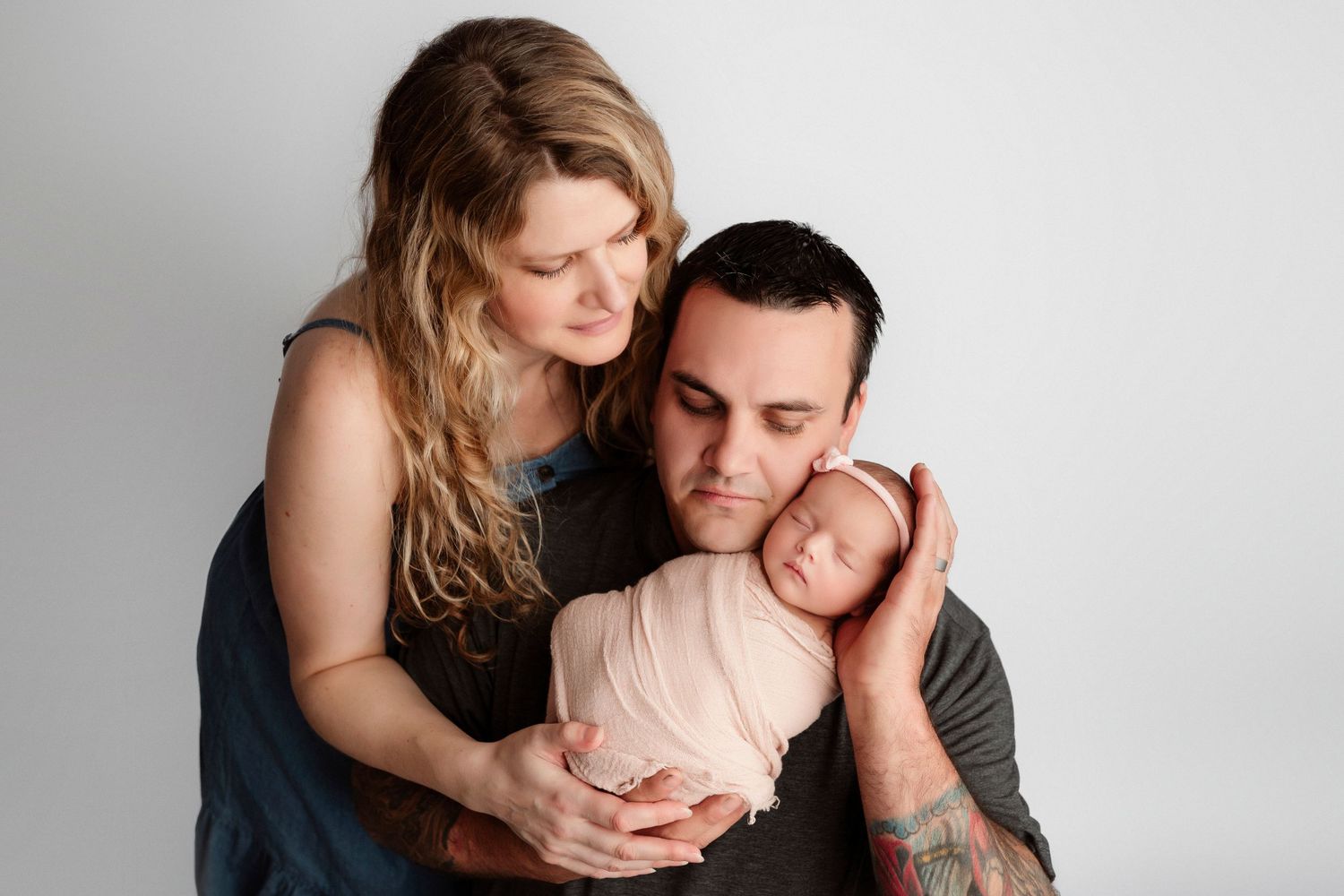 Intimate couples portrait session against white background showing tender embraces and romantic moments.