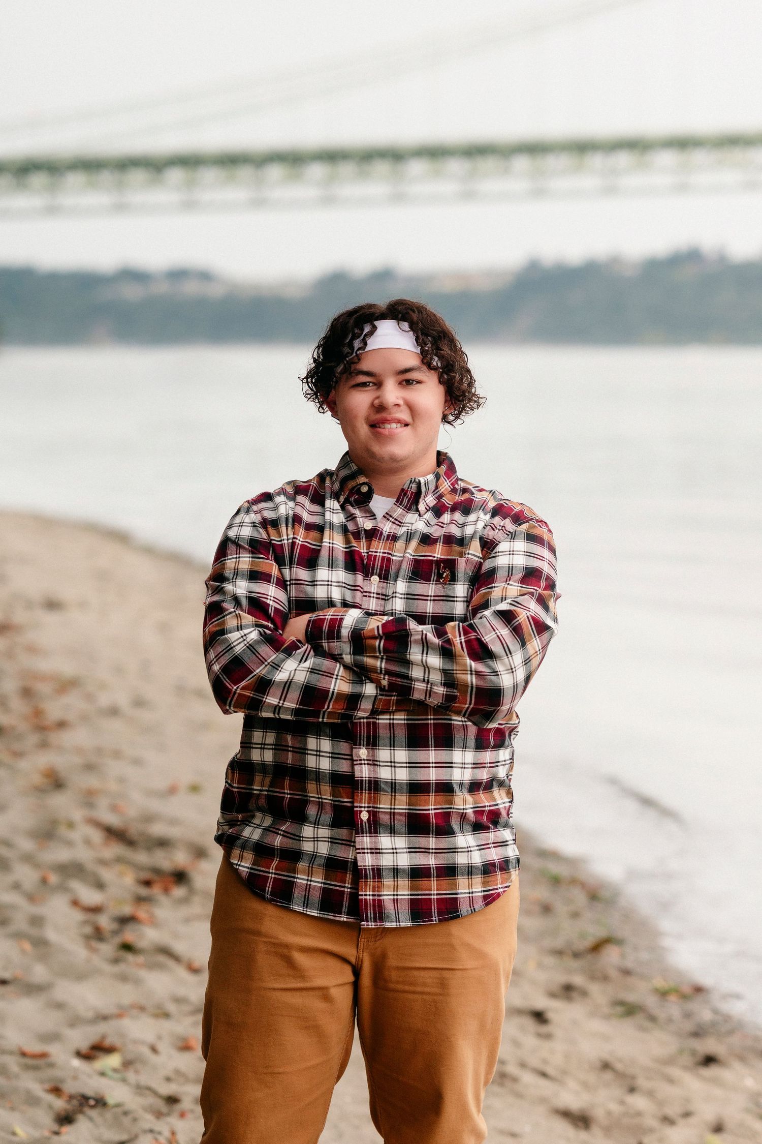 A series of beach portraits showing someone in a plaid flannel shirt and brown pants against a coastal backdrop.