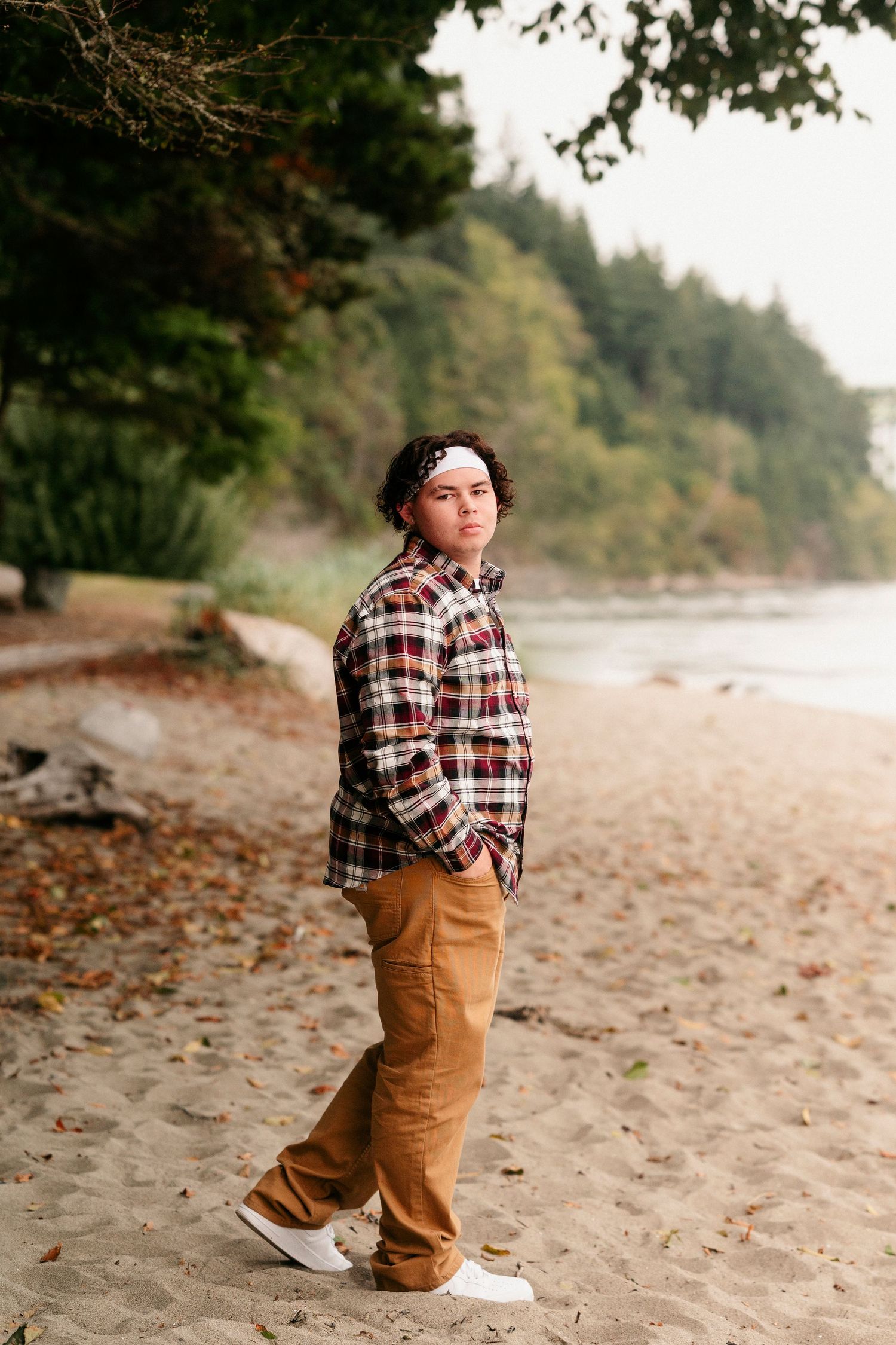 A sequence of photos showing a toddler in a plaid shirt and brown pants playing on a sandy beach.