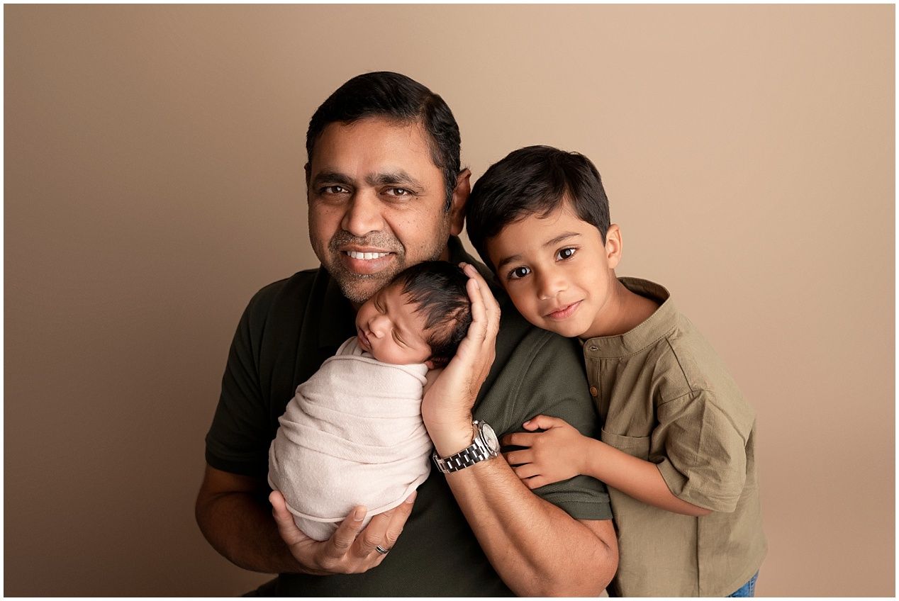 A series of warm-toned family portrait photos showing tender moments between siblings and parents against a neutral backdrop.