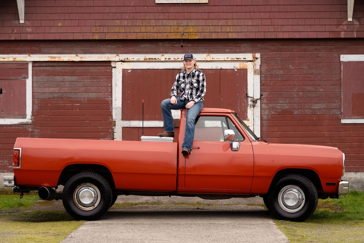 A red vintage Ford pickup truck is shown from four different angles parked in front of a red barn.