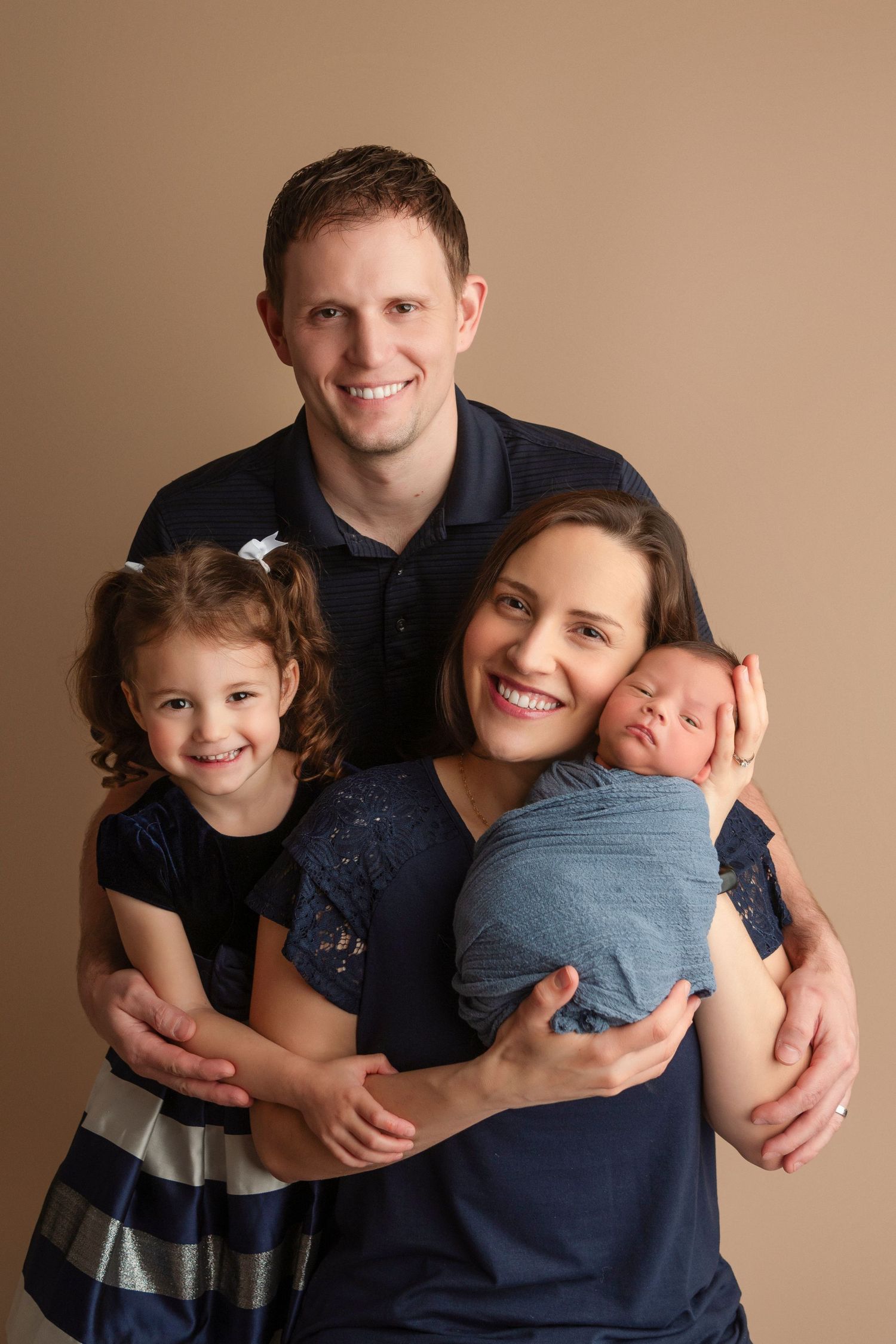 Family portrait series showing loving embraces and warm smiles against a neutral beige background.