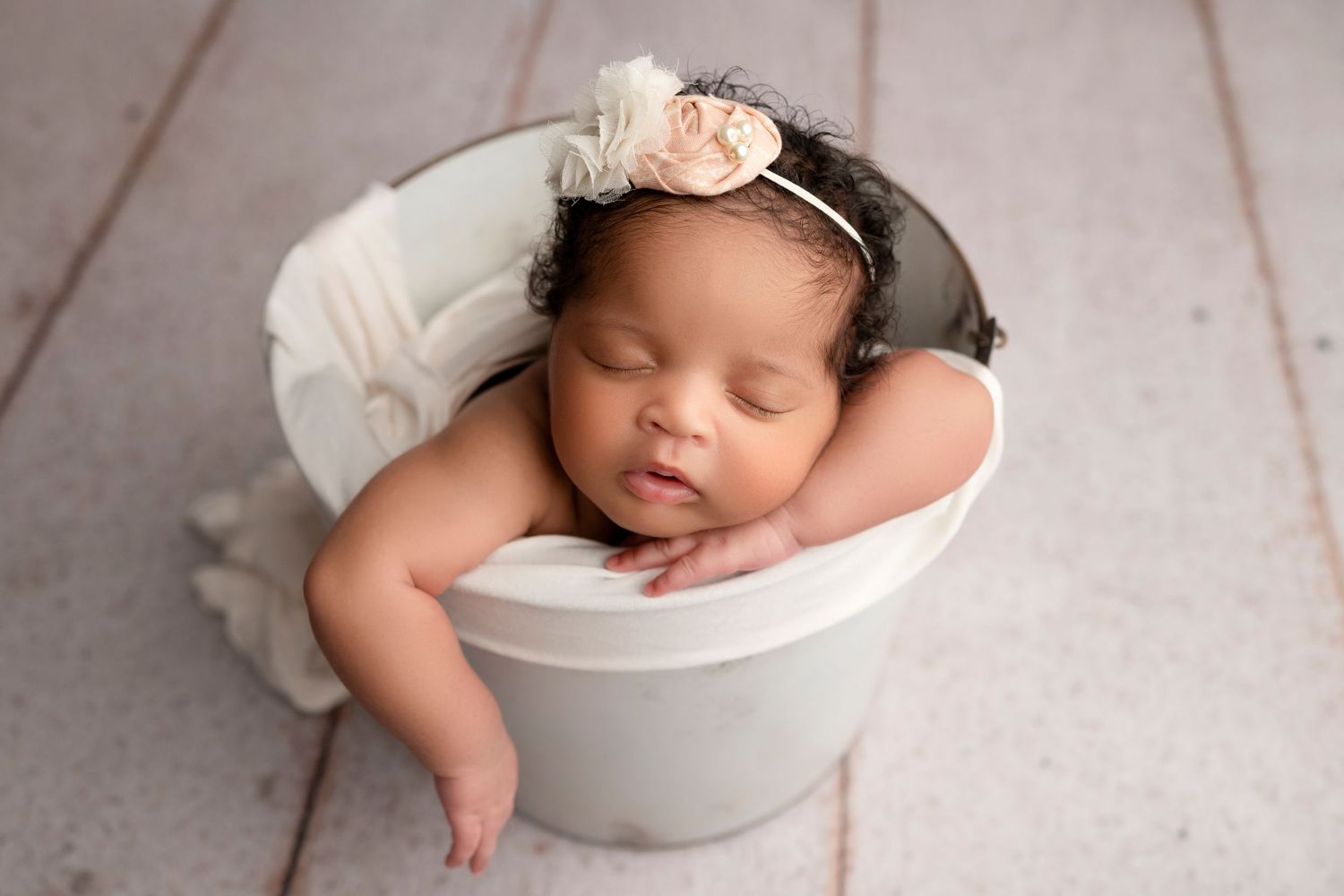 Collage of newborn baby photography showing peaceful sleeping poses in white bowls and blankets.