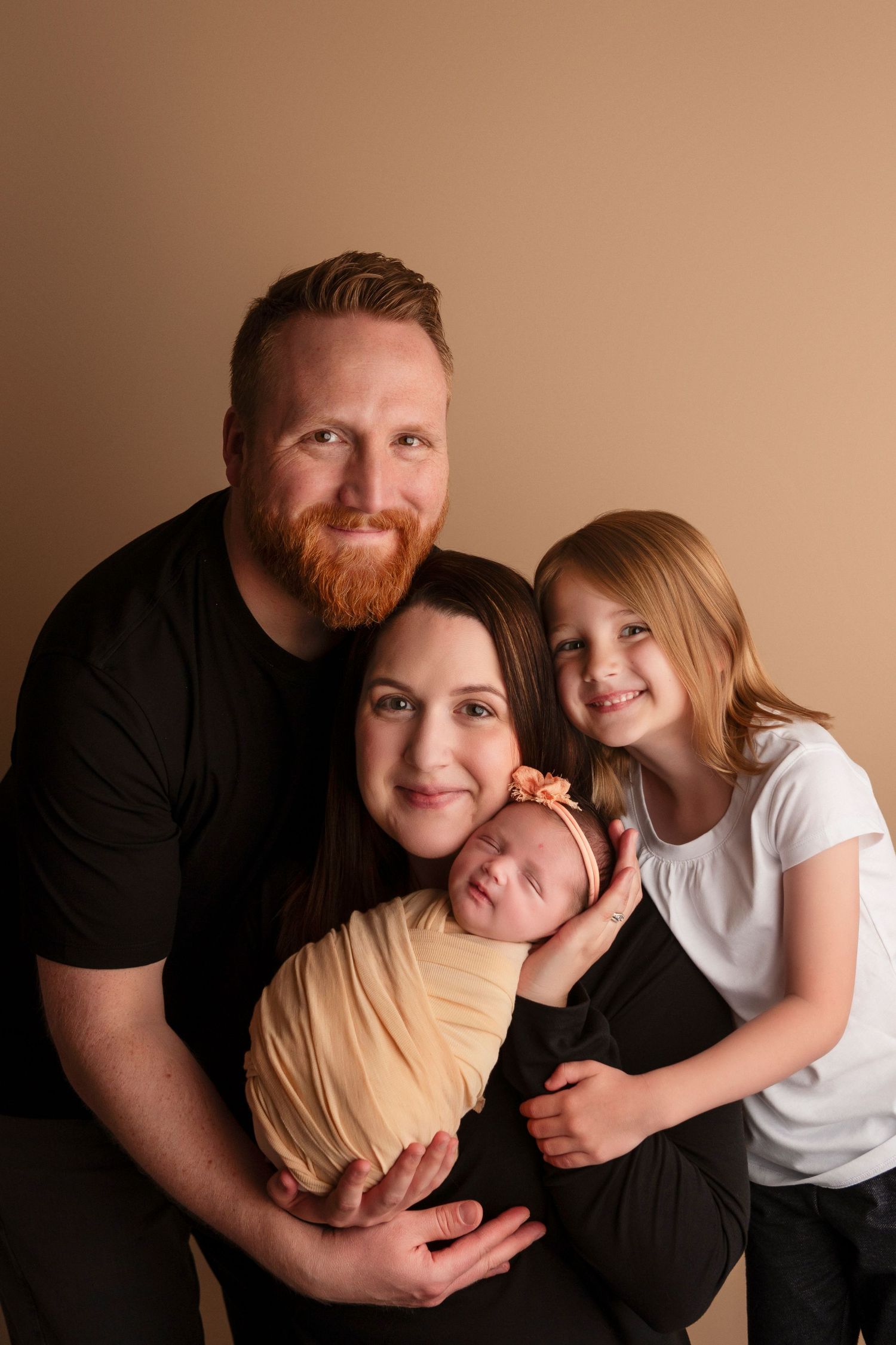 A series of warm-toned family portraits showing tender embraces and joyful moments against a neutral background.
