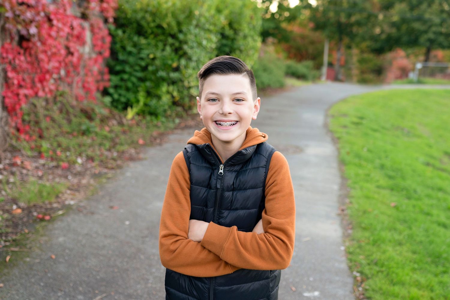 A series of outdoor portrait photos taken on a path with autumn foliage and green grass in the background.