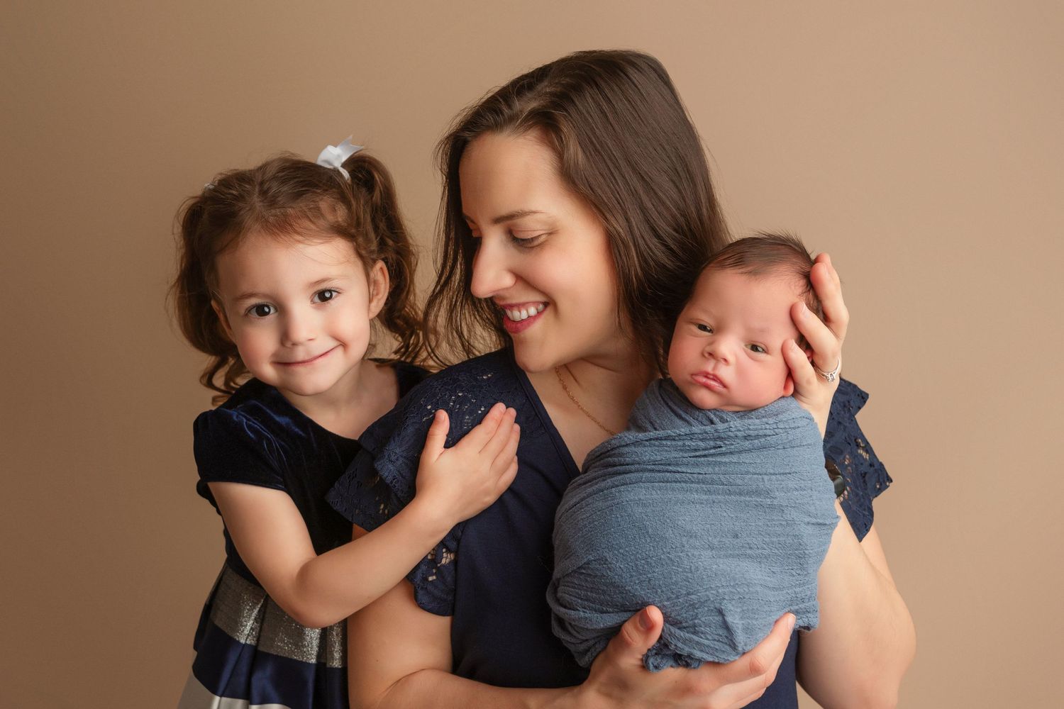 A collection of intimate family moments showing tender embraces and cuddles between parent and child against neutral backgrounds.