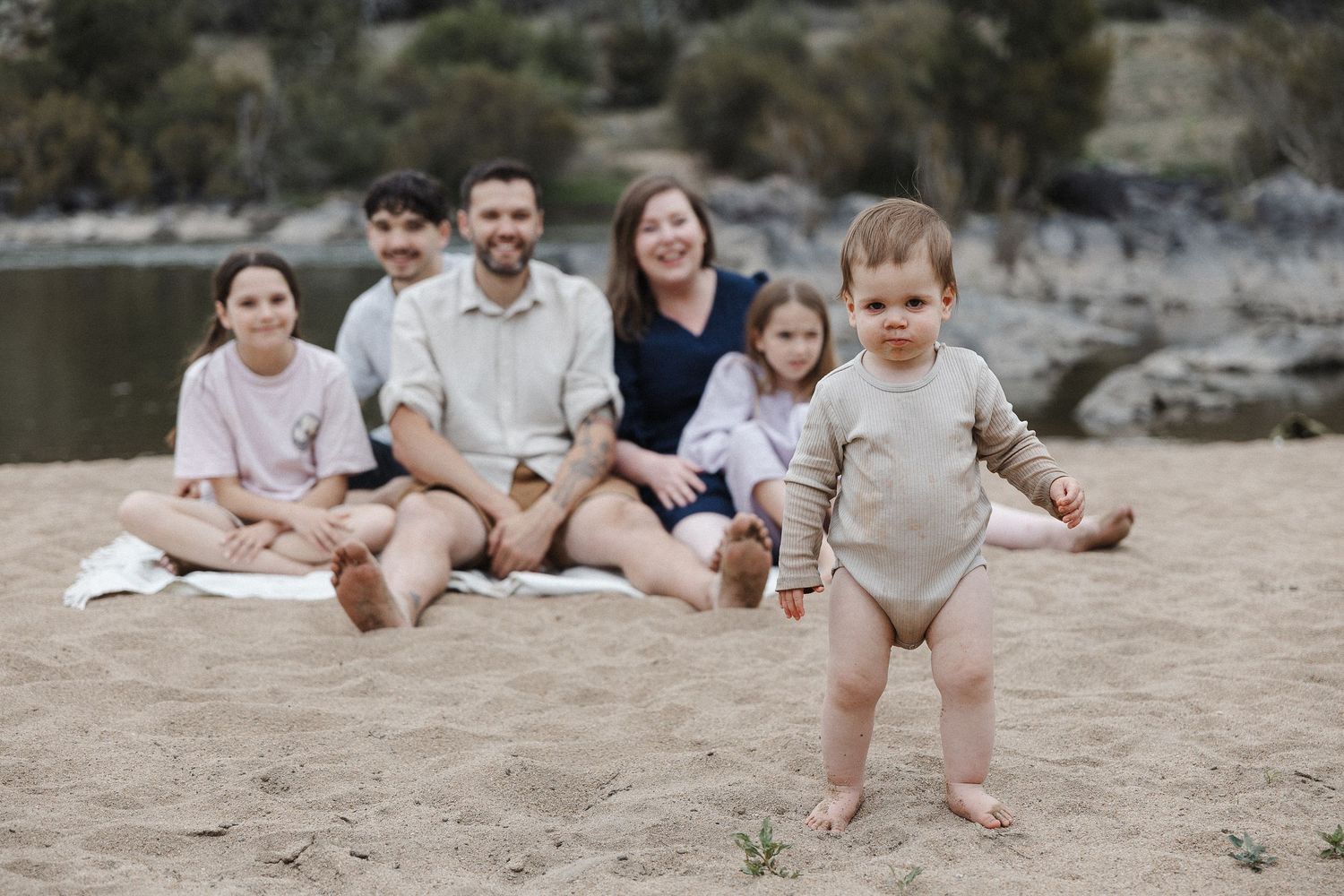 A messy toddler with his loving family in Canberra family photo session
