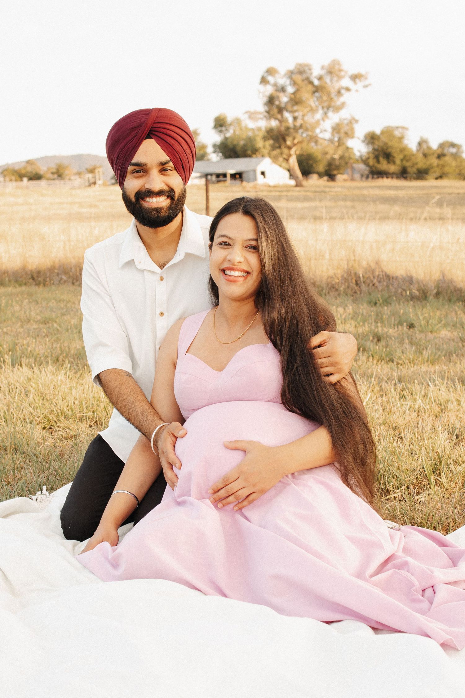 pregnancy photoshoot with couple in front of heritage farmhouse in Canberra