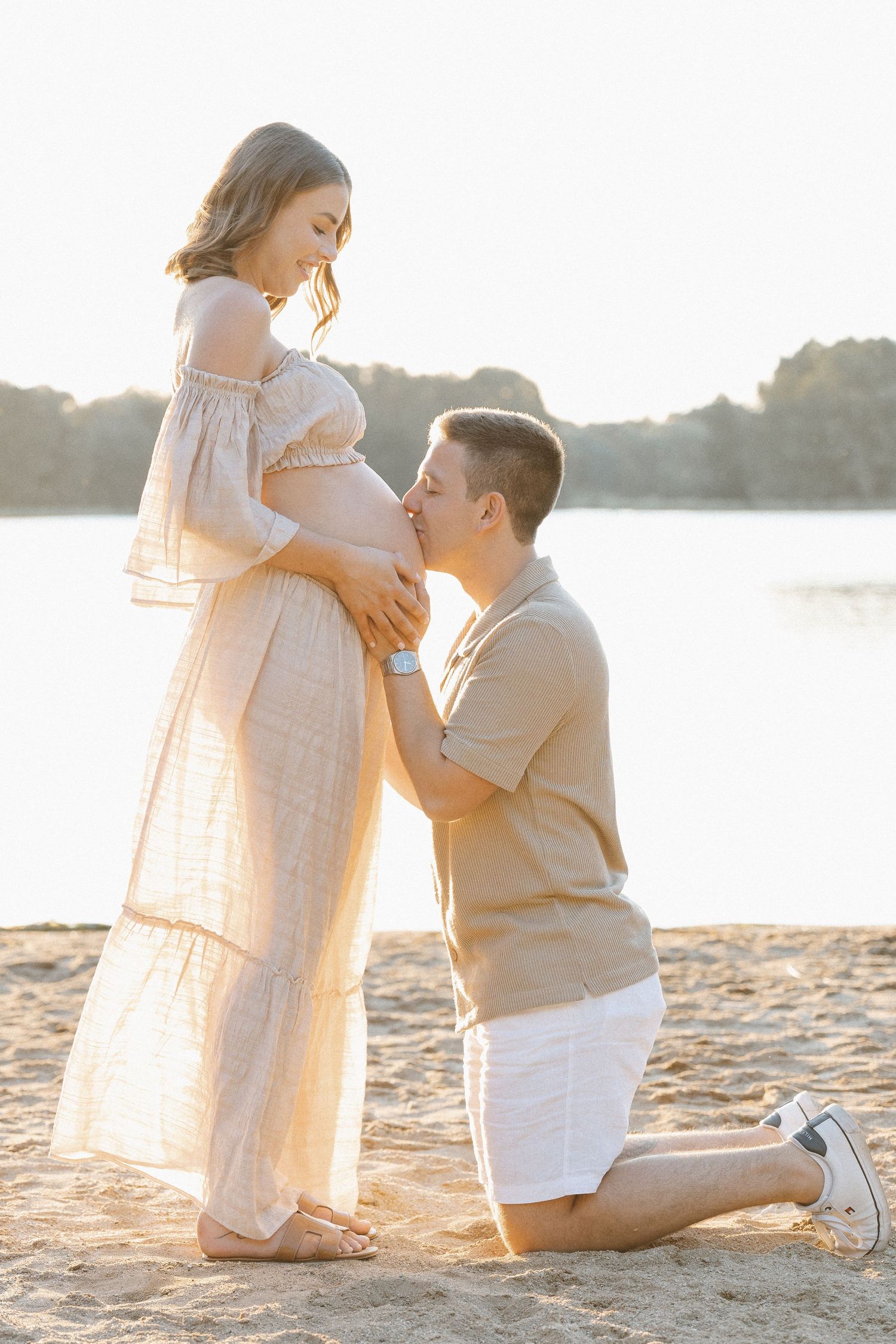 maternity photographer in canberra with father kissing mothers belly
