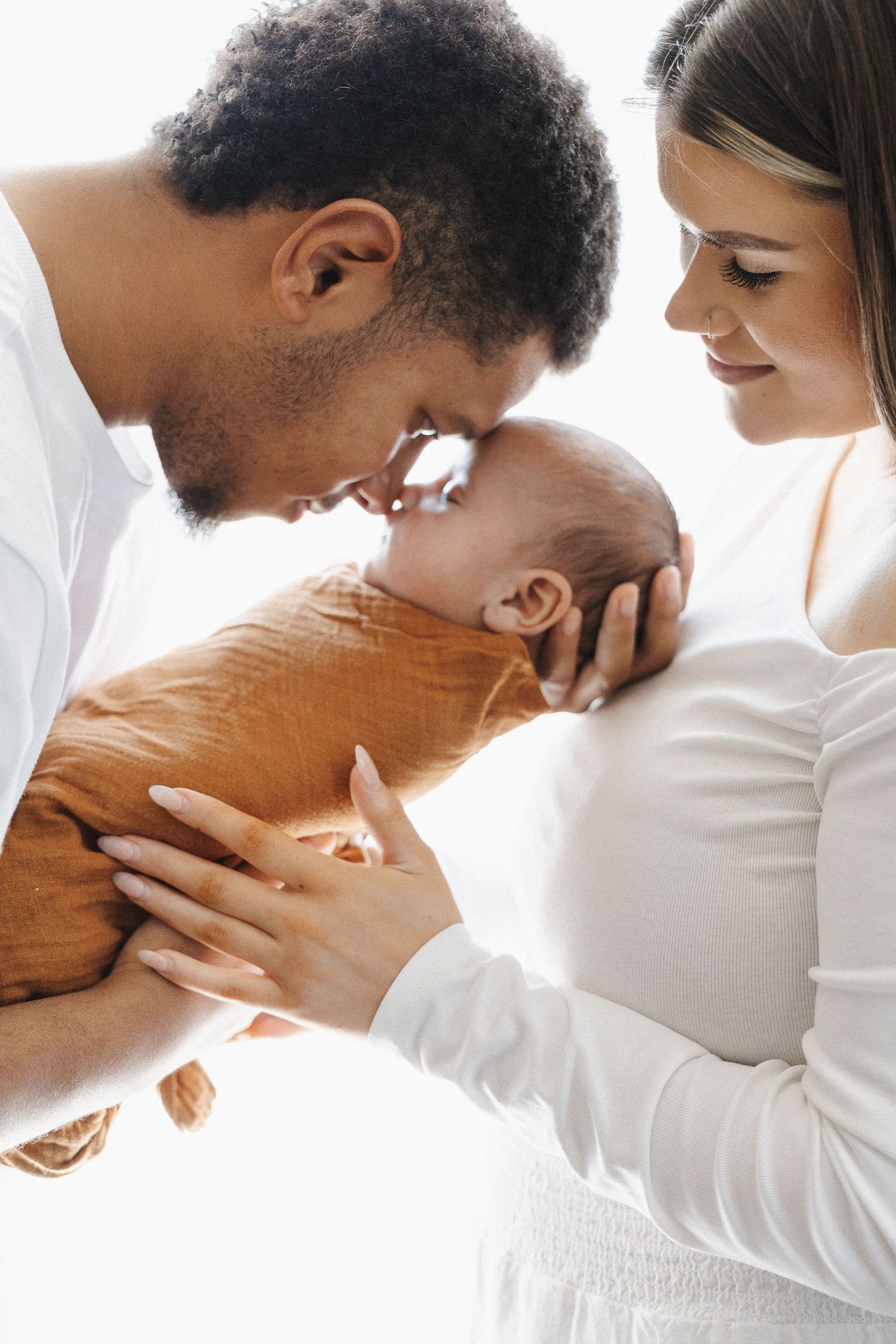 Two parents with their newborn baby in Belconnen Canberra photography studio