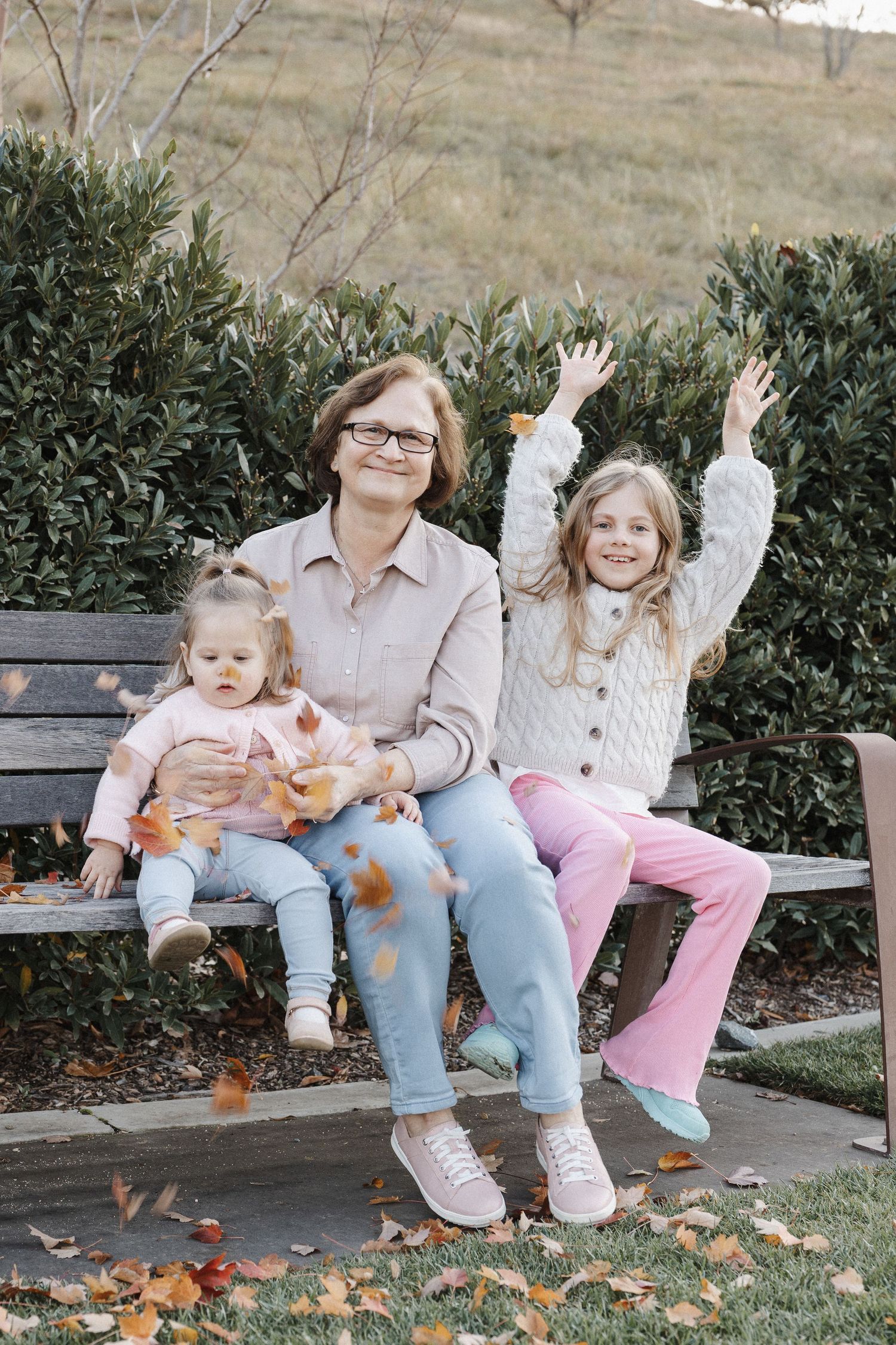 Throwing leaves in a Canberra autumn family photoshoot