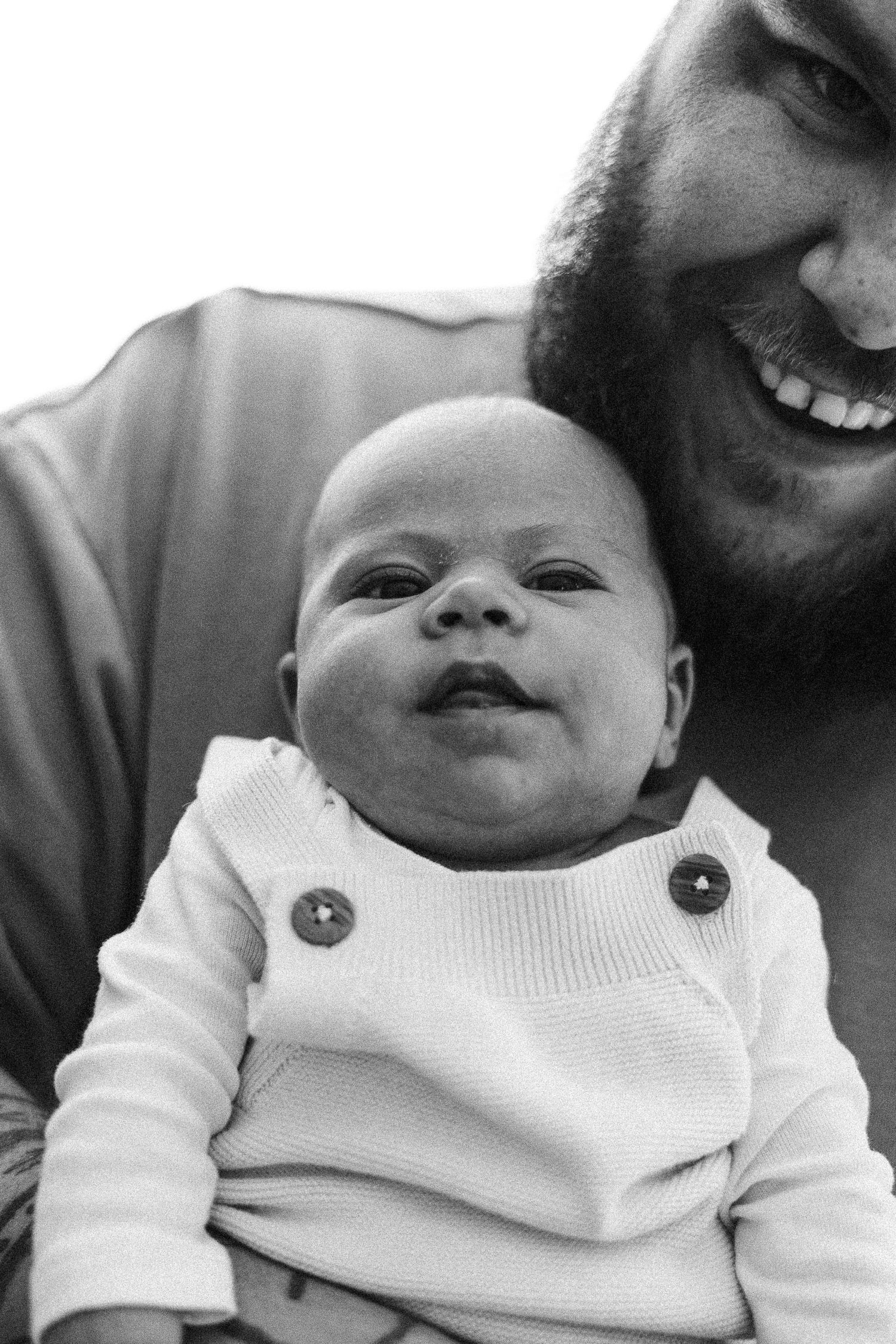 Dad and baby laugh at the camera in Canberra photography studio