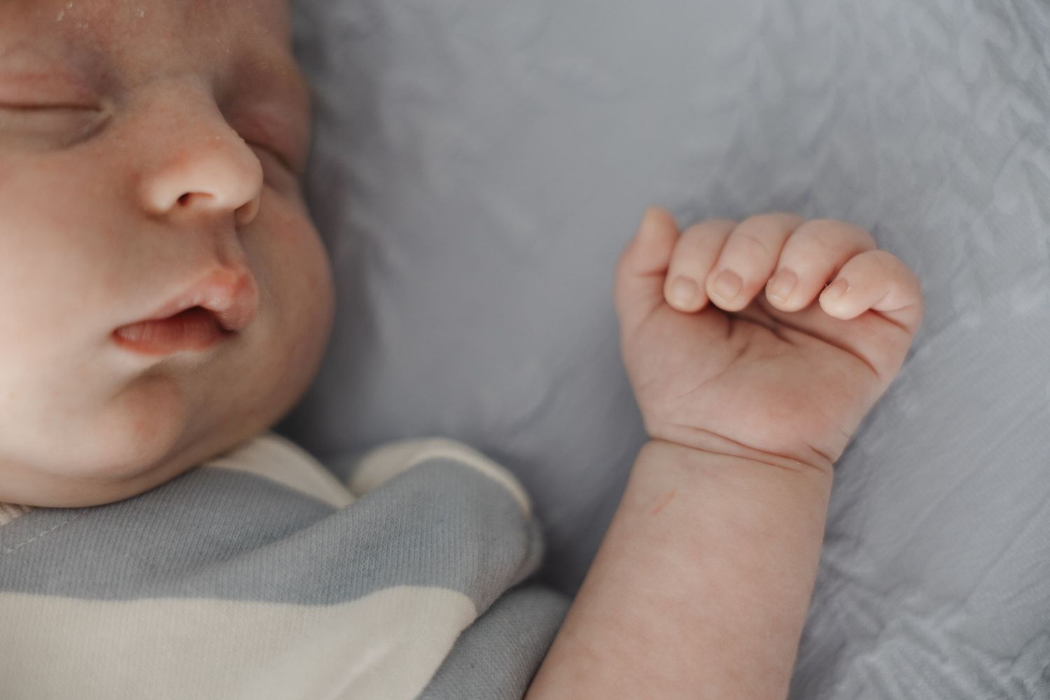 close up of sleeping baby's face and hand in Canberra newborn photoshoot
