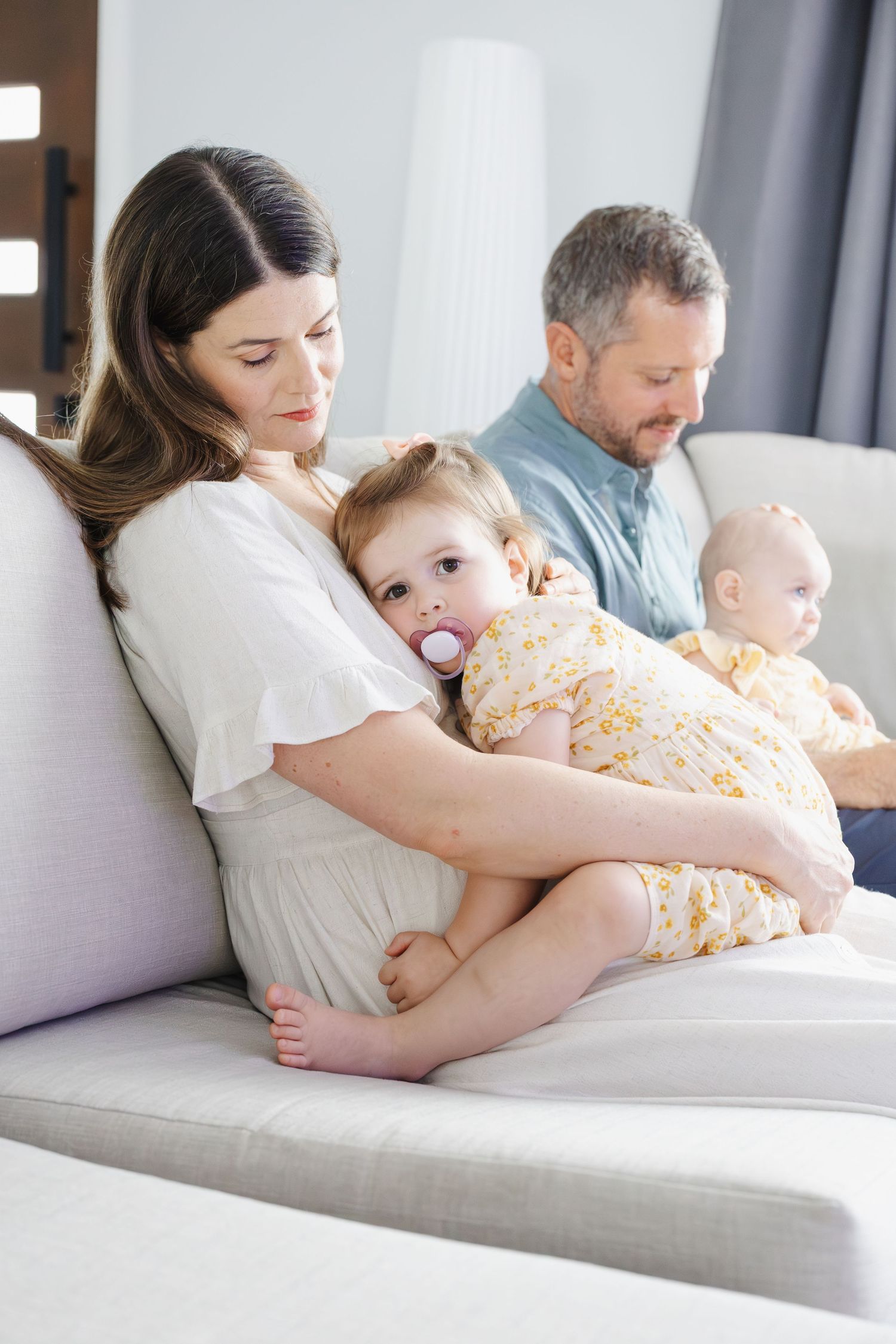 toddler cuddles mum during family photoshoot in Canberra
