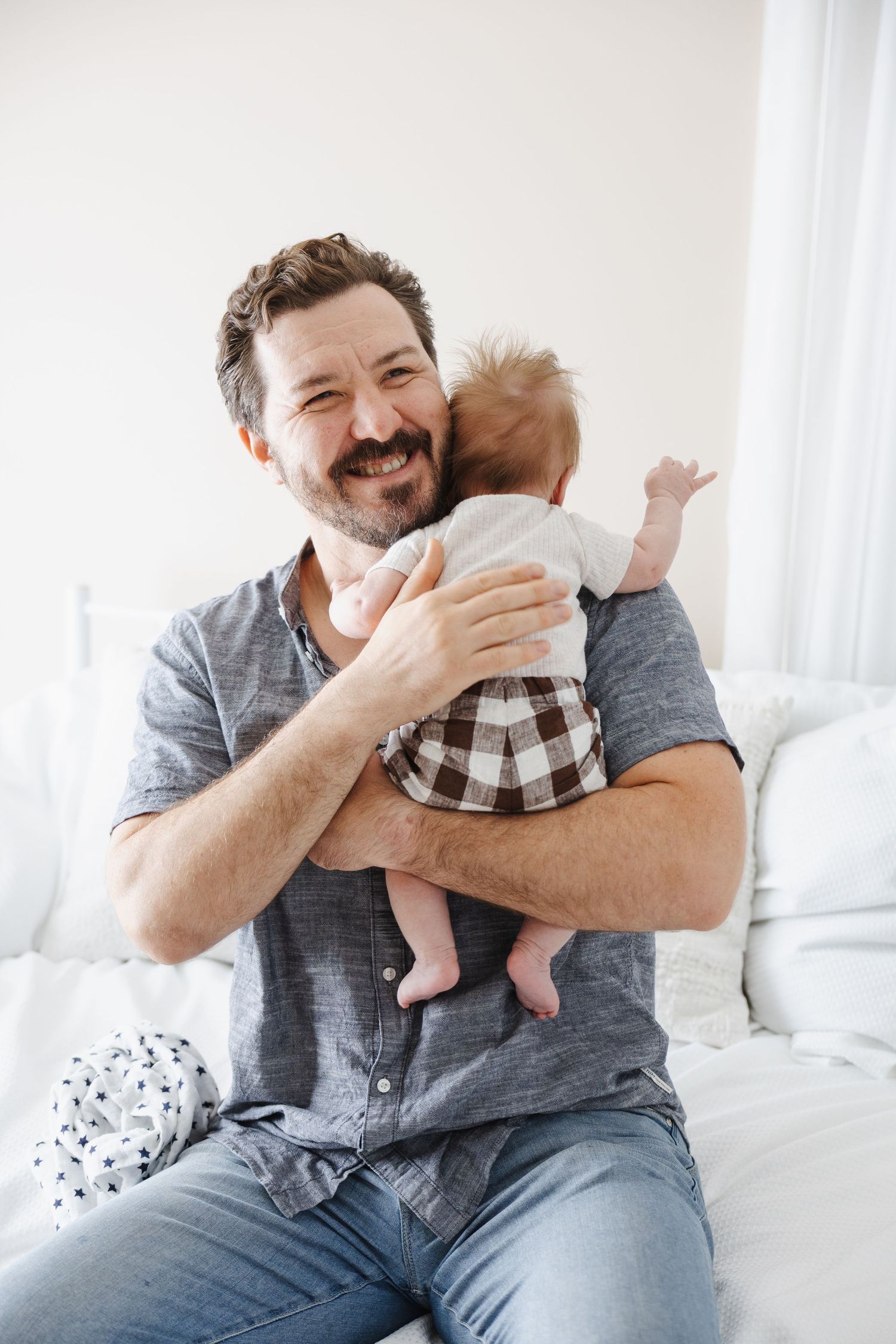Dad burps baby during Canberra newborn photoshoot