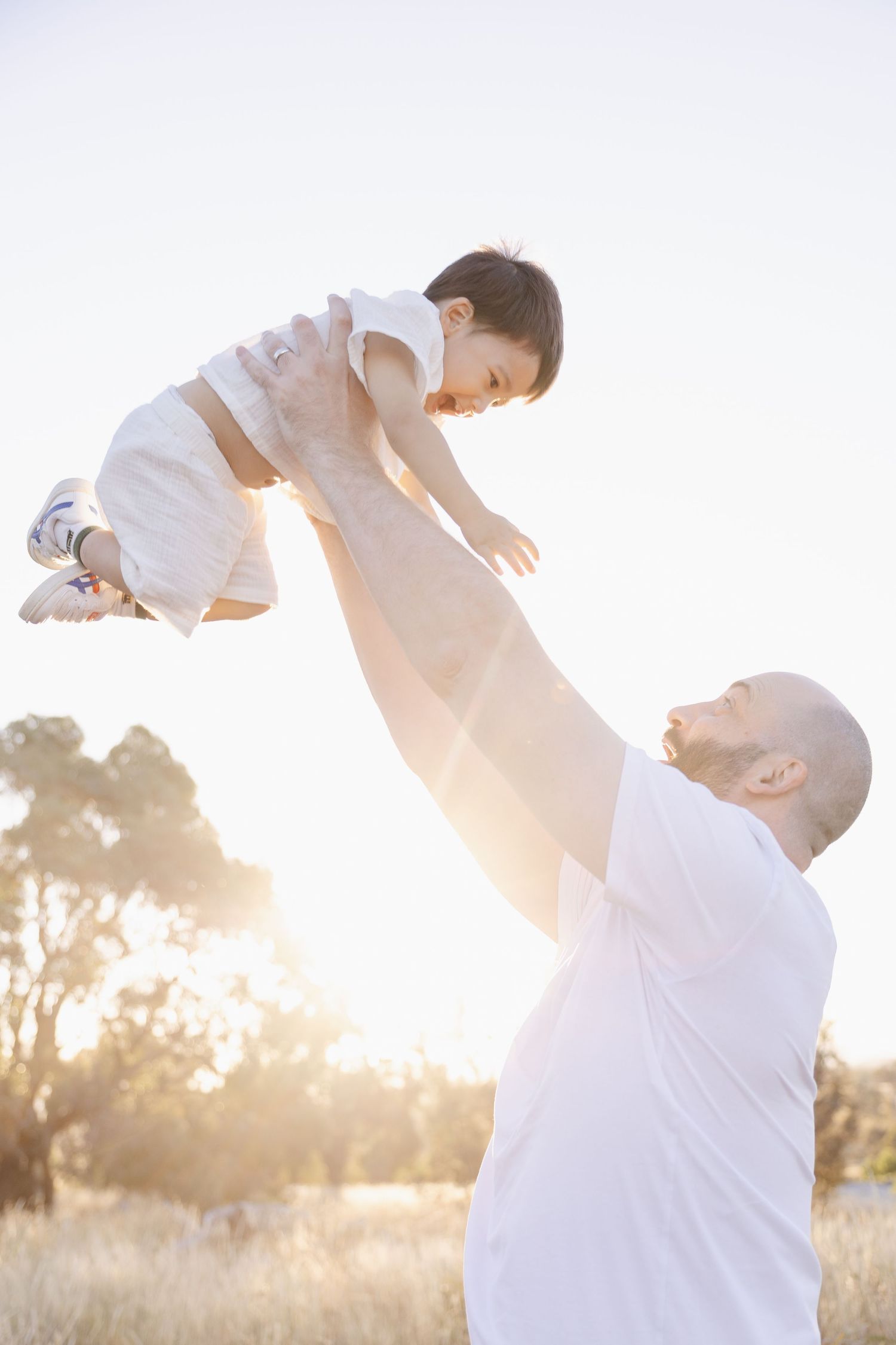 Dad throws toddler in Canberra family photoshoot