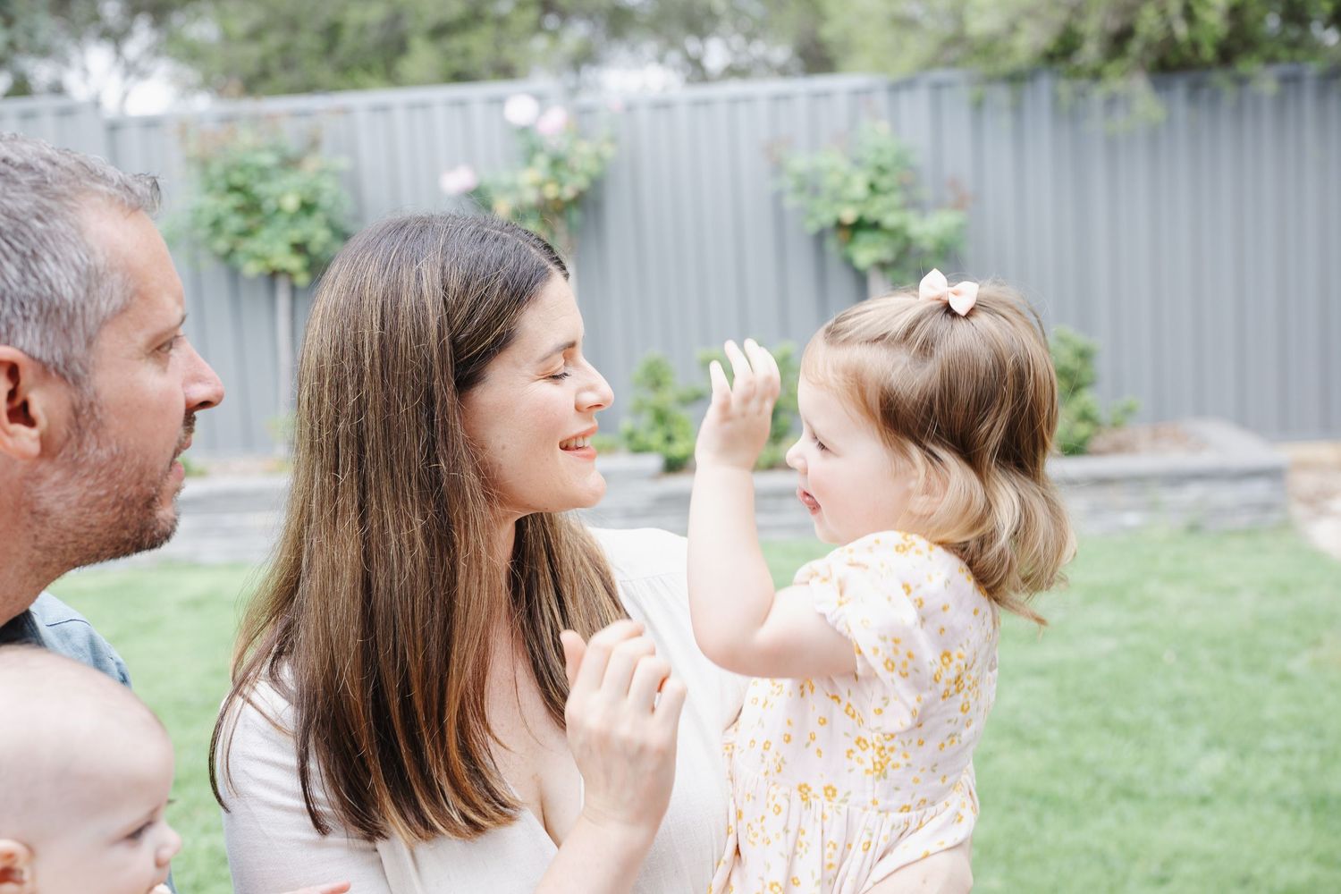 Toddler plays with mum during photoshoot