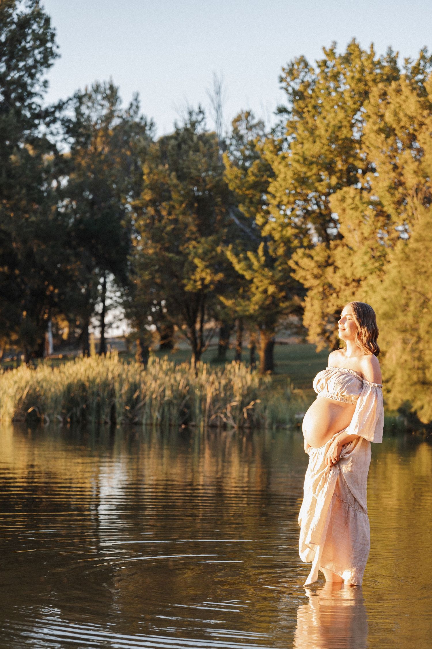 Pregnant woman in the water in an outdoor Canberra pregnancy photoshoot