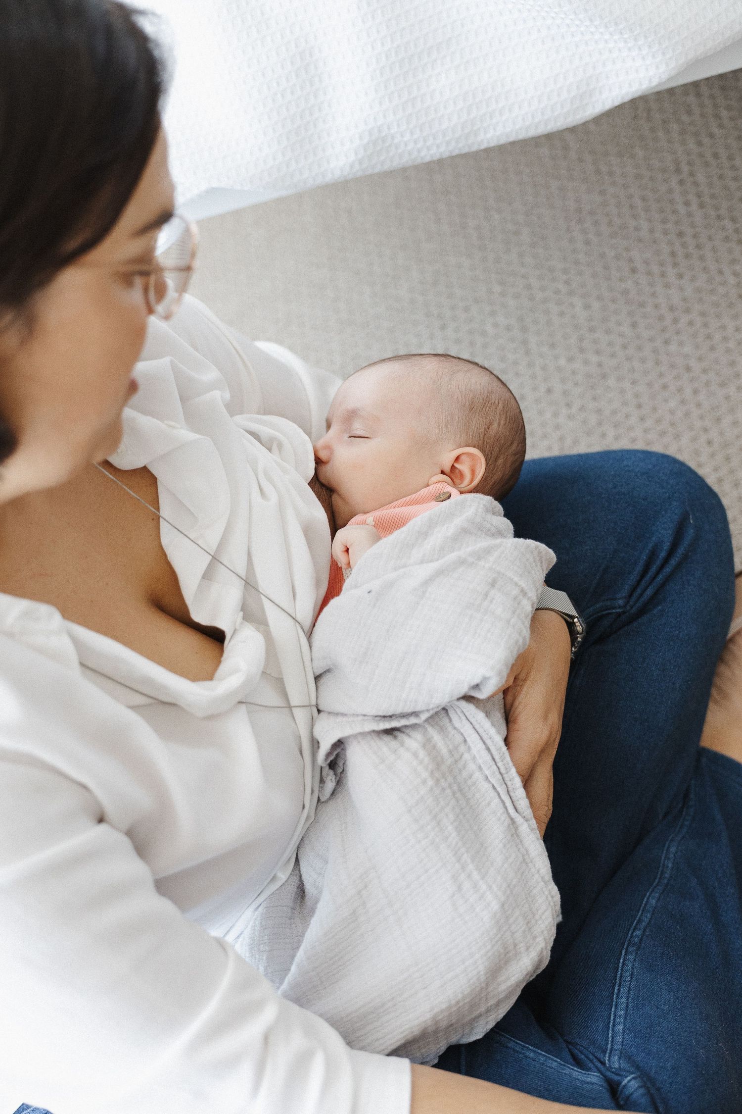 newborn baby breastfed on the floor in Belconnen Canberra photography studio