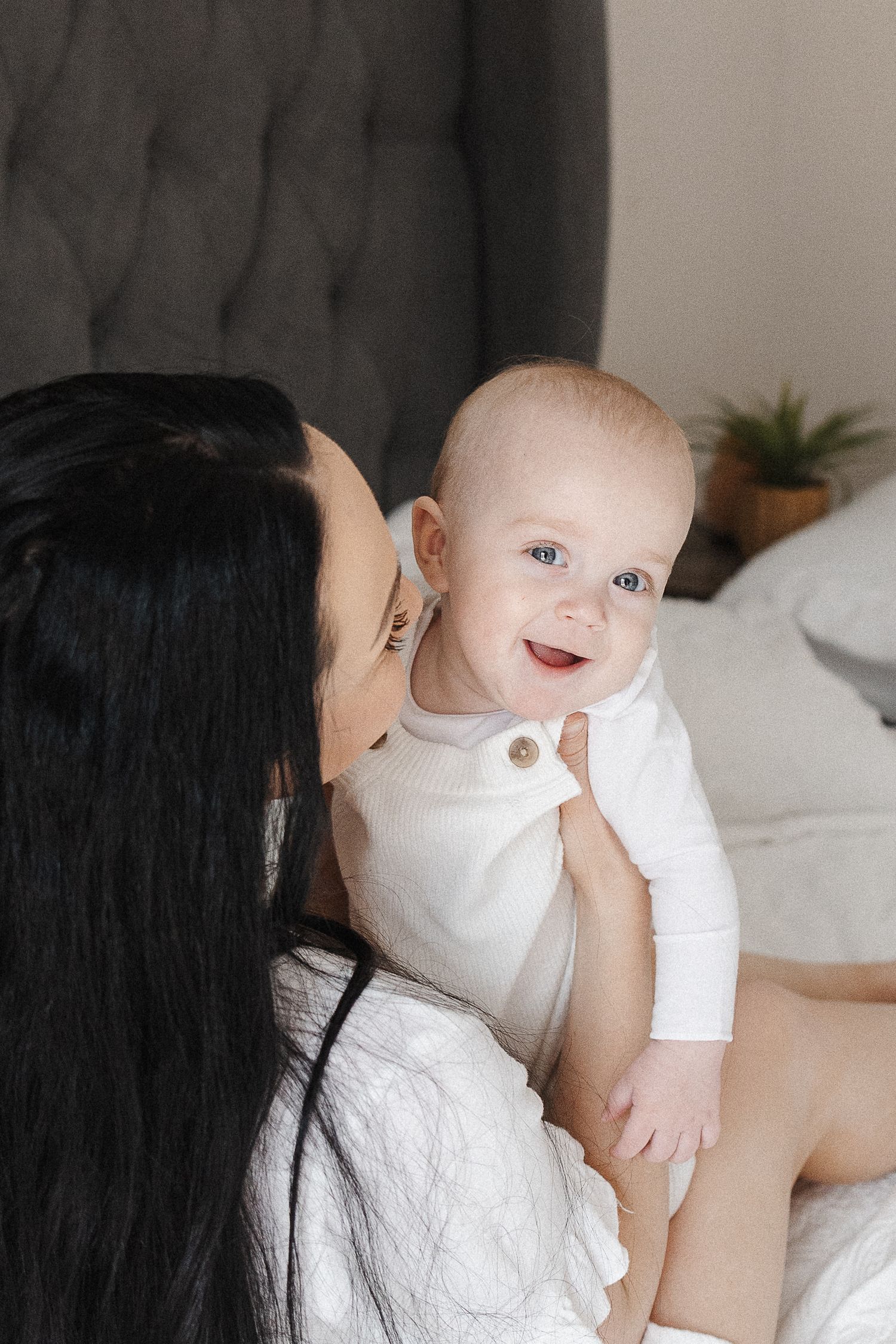 Laughing baby with mum in Canberra lifestyle family photoshoot in home