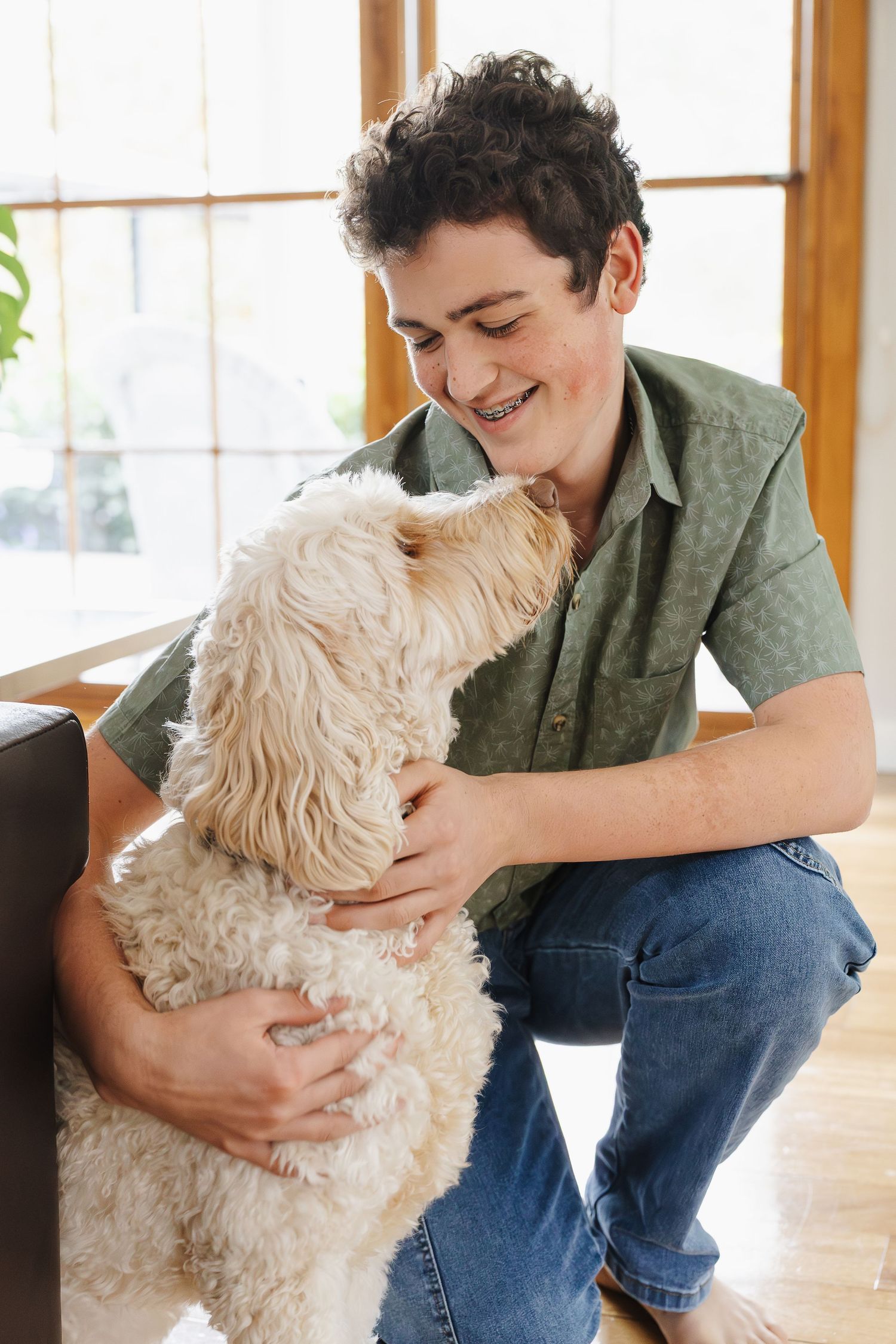 A boy smiles at his dog in a Canberra family photoshoot