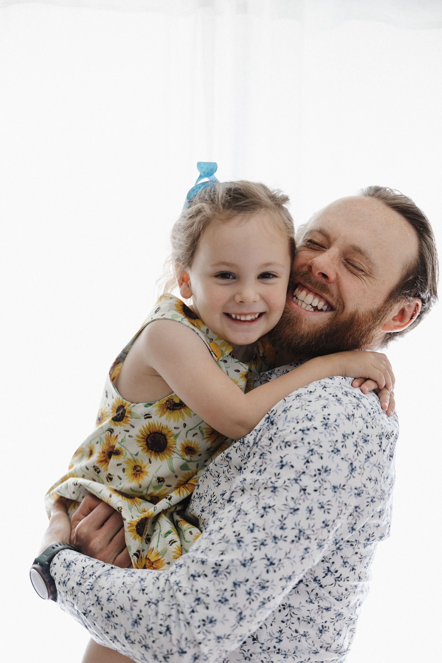 Girl playing with her dad in a family photoshoot in Canberra studio