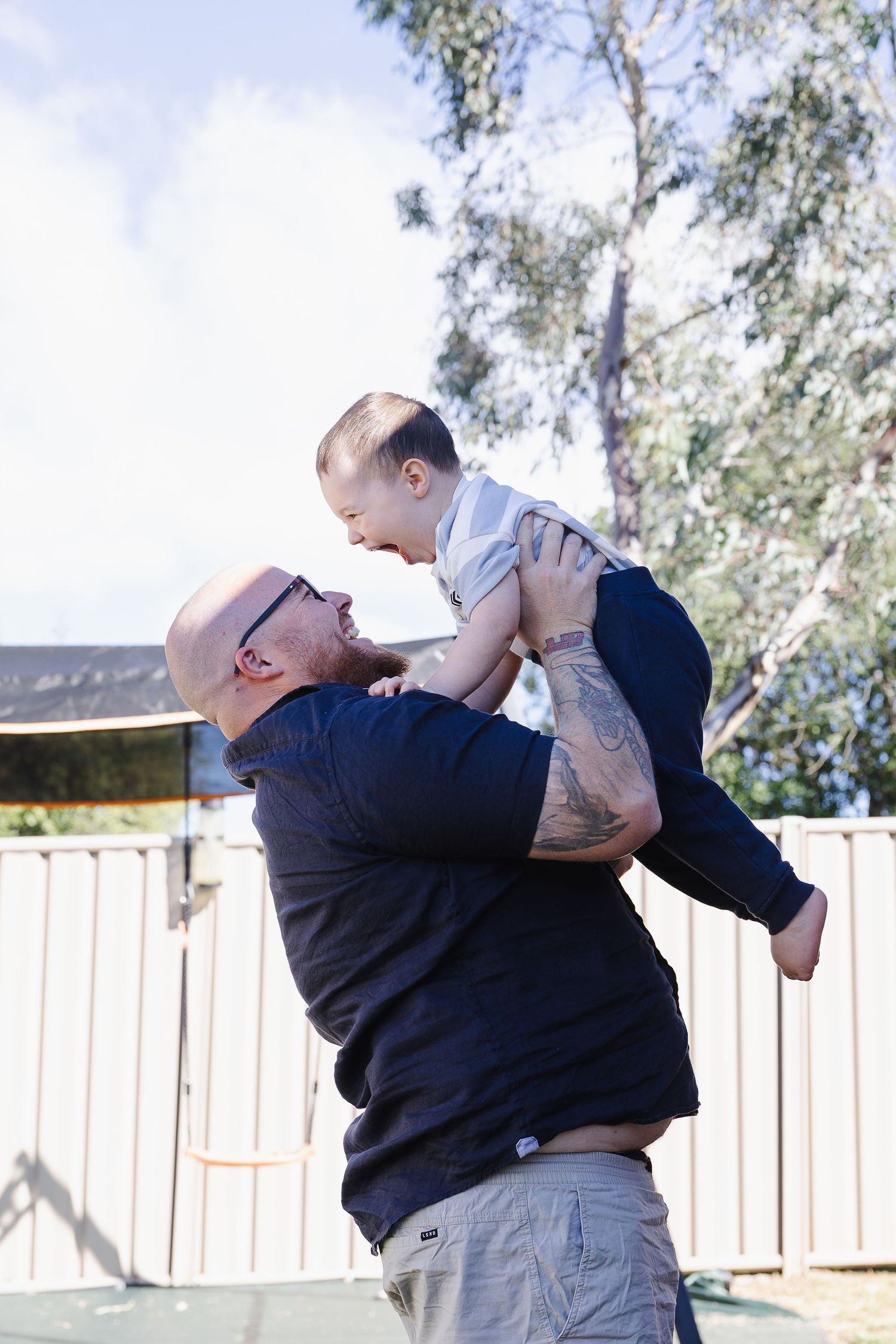 dad throws his son during a Canberra family photoshoot
