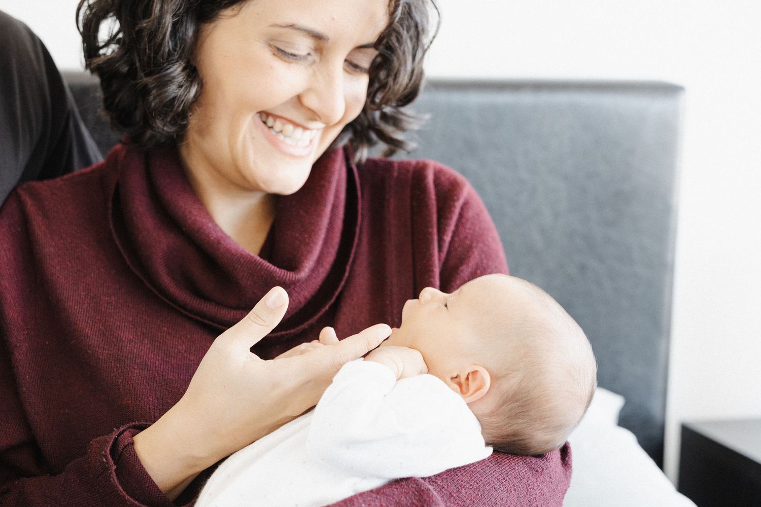 Mother laughing with her newborn baby in Canberra