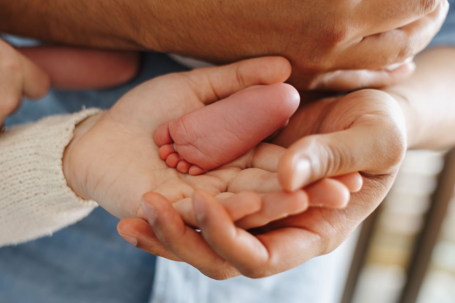 tiny foot in mum and dads hand in a Canberra newborn family photoshoot