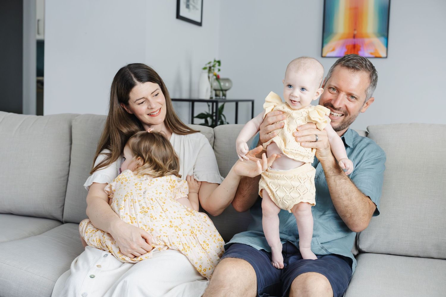 Family plays on the couch during their Canberra family photosession
