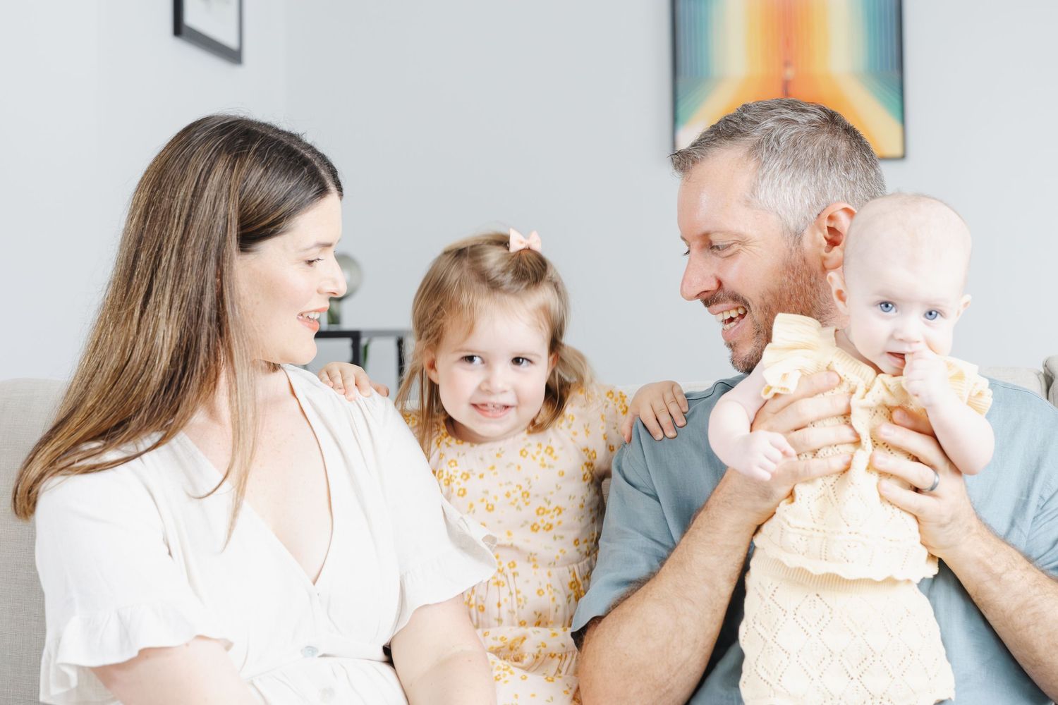 Smiling family on the couch during Canberra family photoshoot