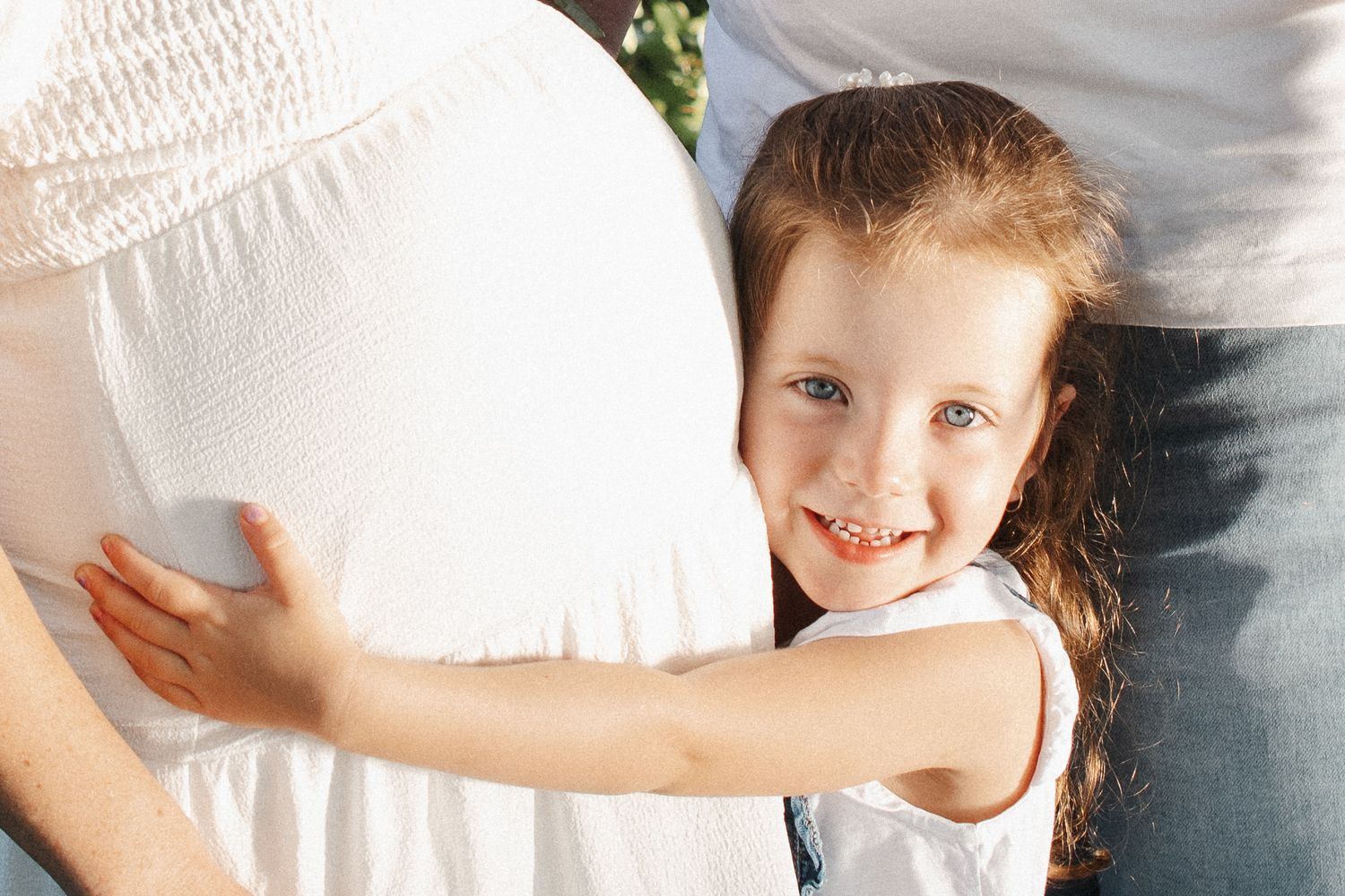 proud big sister with pregnant belly in Canberra maternity photoshoot