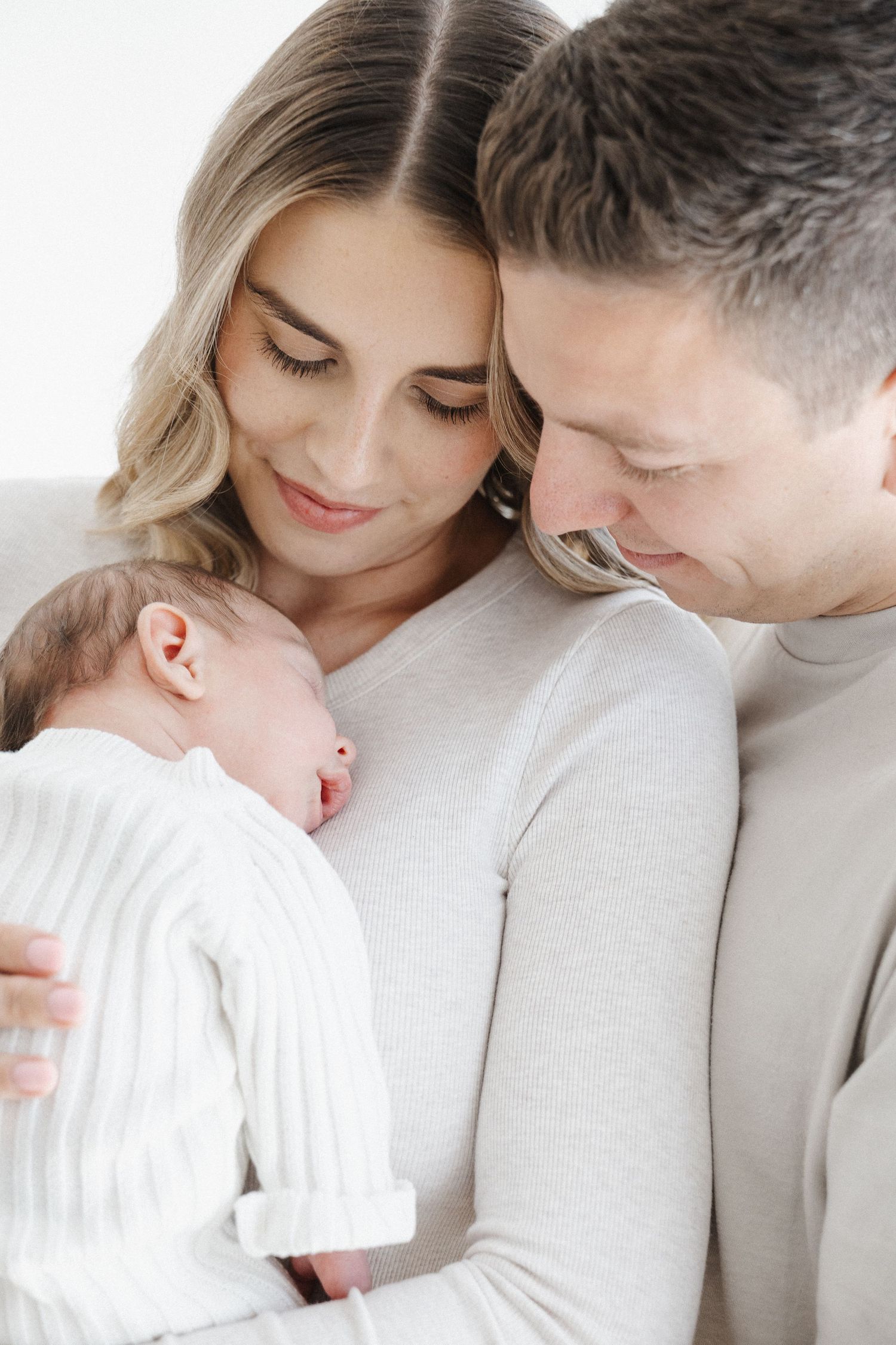 Proud parents of newborn gaze at their baby in Canberra