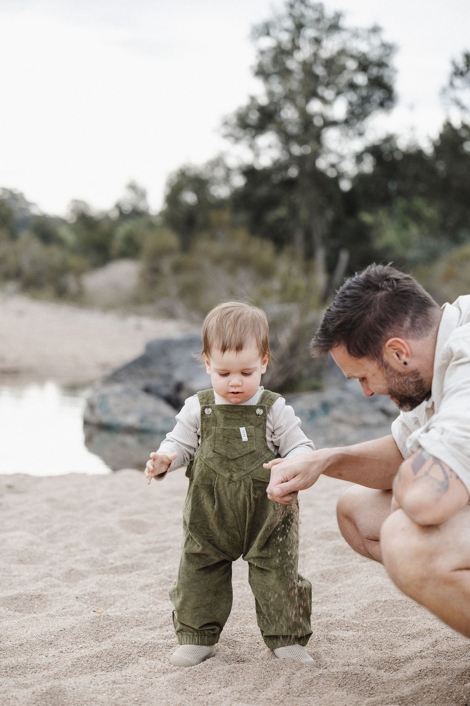 A toddler with his dad in Canberra family photoshoot on the beach