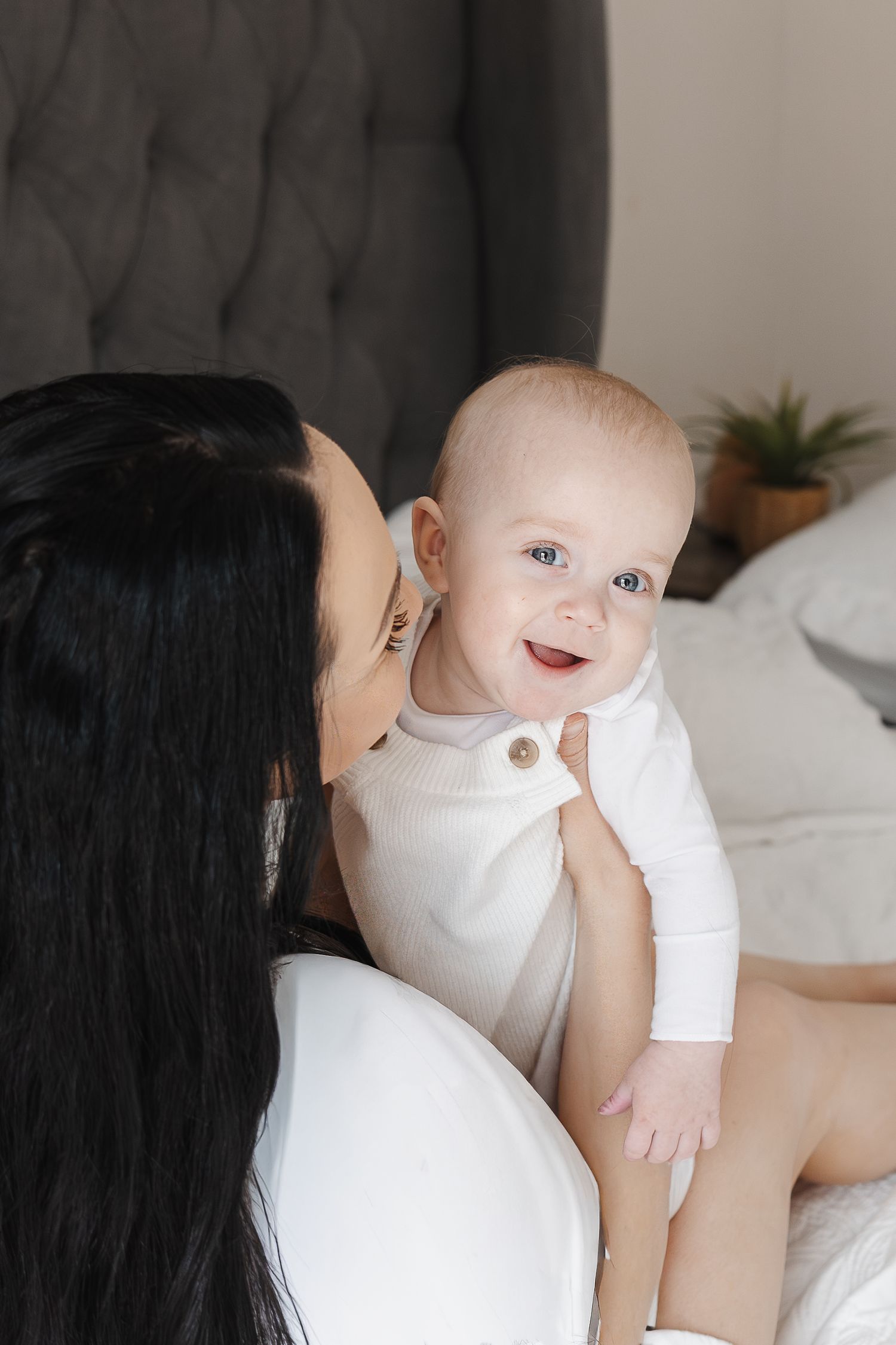Baby laughs at the camera in family photoshoot in Canberra