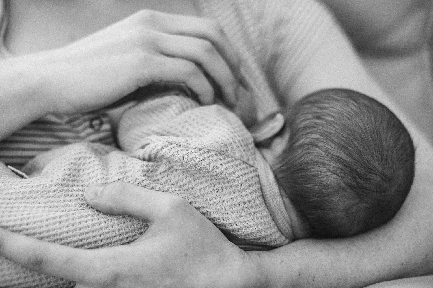 Breastfeeding newborn baby in Canberra with photographer