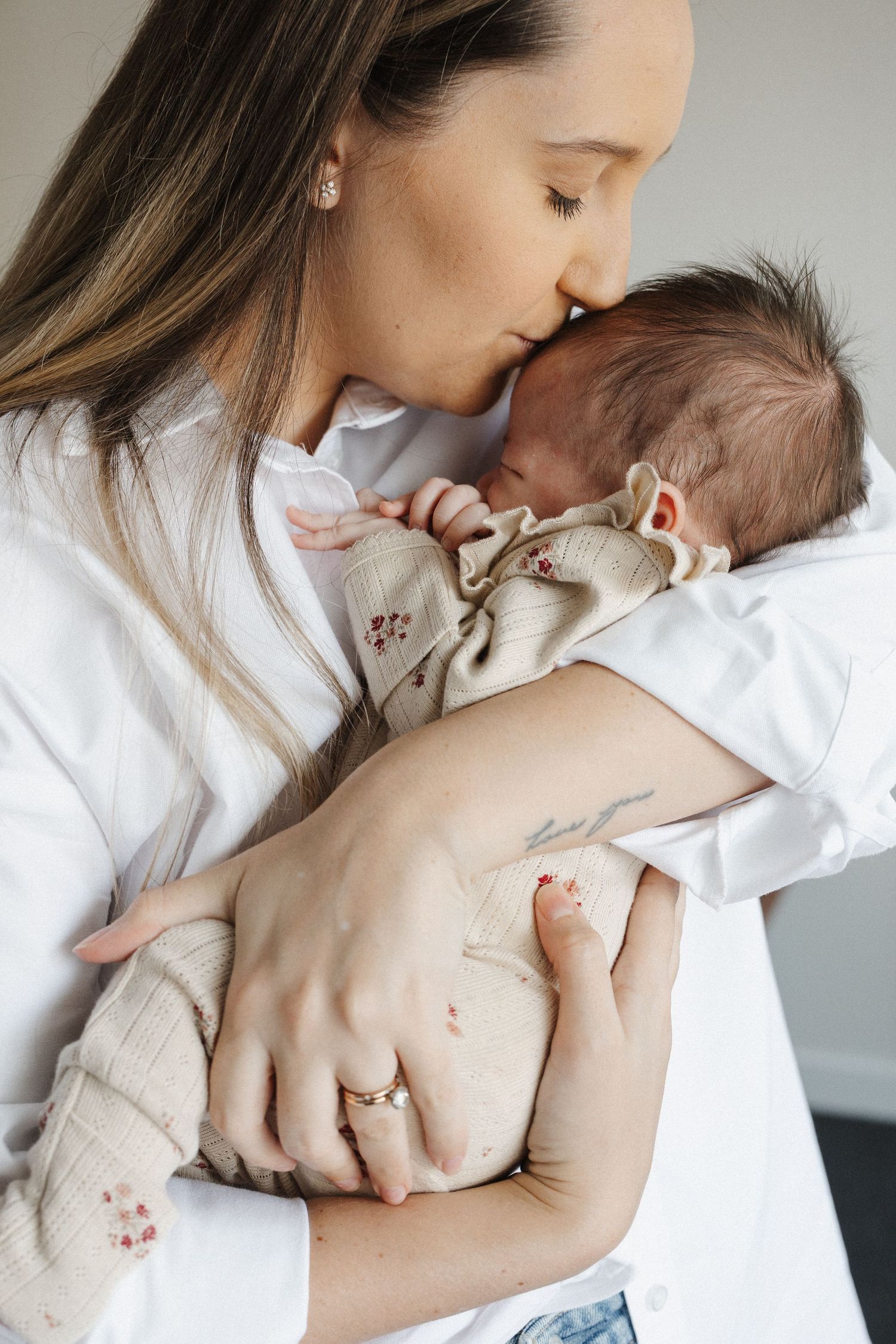 Mother kisses her newborn baby in Canberra