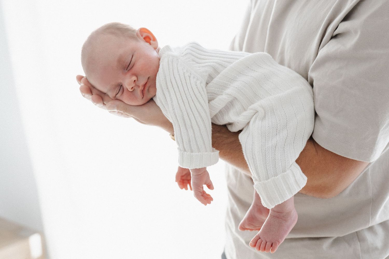 Newborn baby sleeps on his father's forearm in Canberra