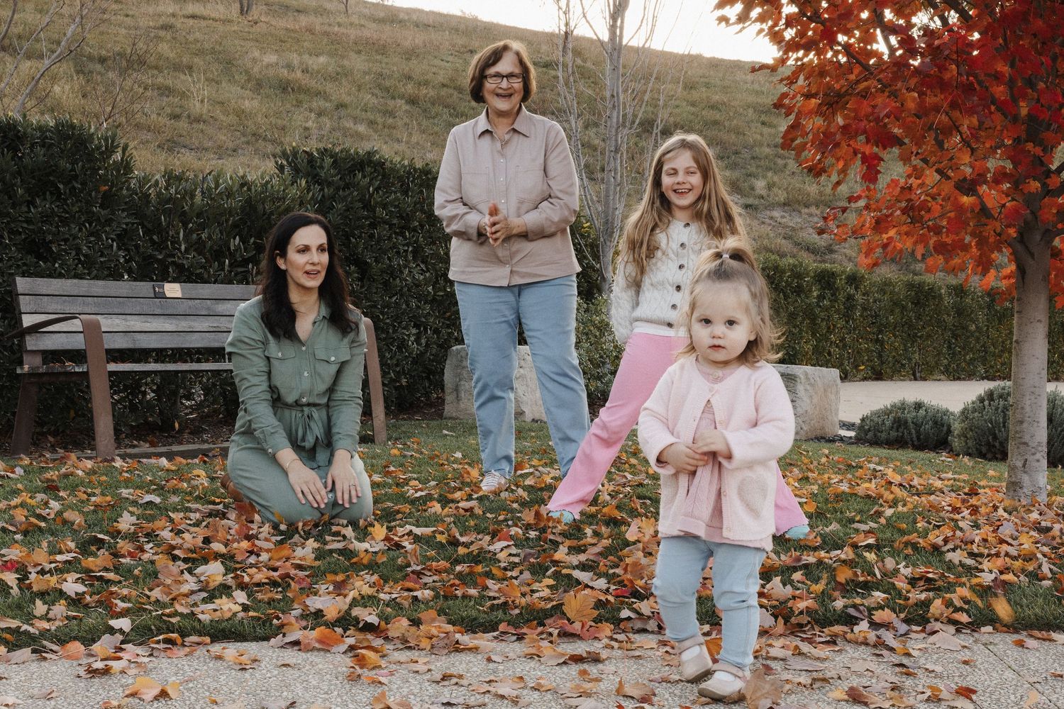 Family playing in autumn leaves in Canberra Arboretum photoshoot