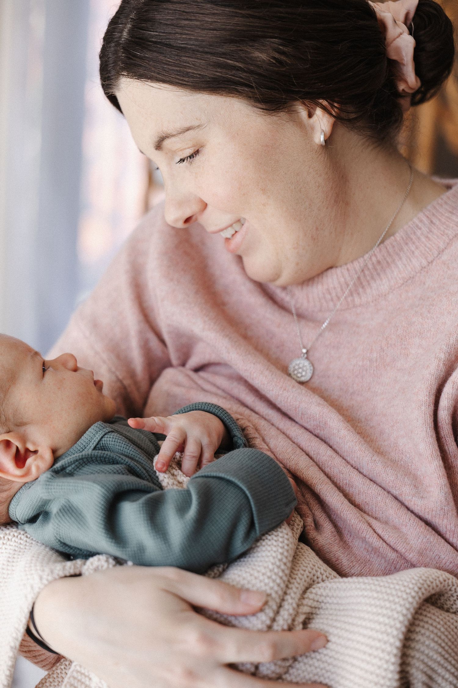 Mother gazes with love at her newborn baby boy in Belconnen Canberra photography studio