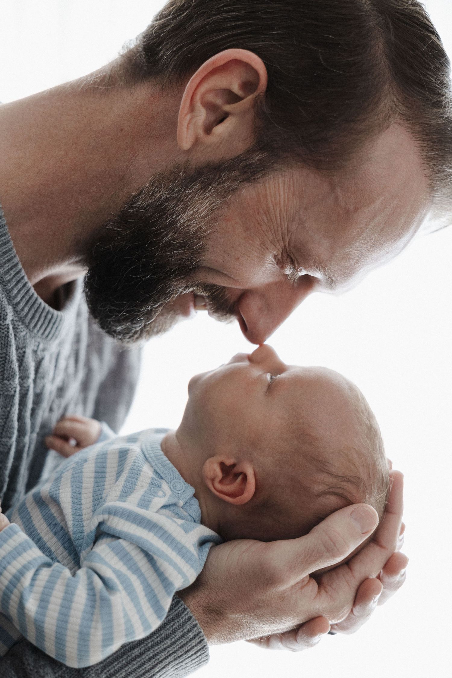 Dad smiling at his newborn baby in a Canberra photoshoot