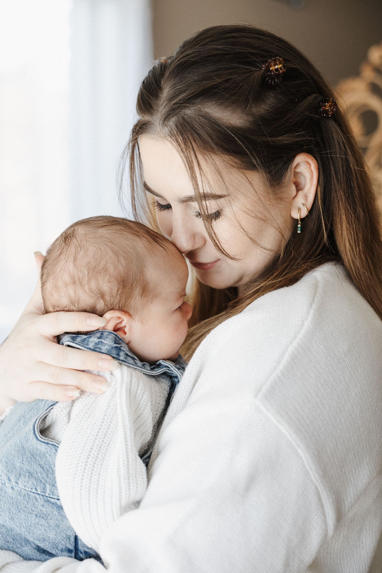 Mother kisses newborn baby in Belconnen Canberra photography studio